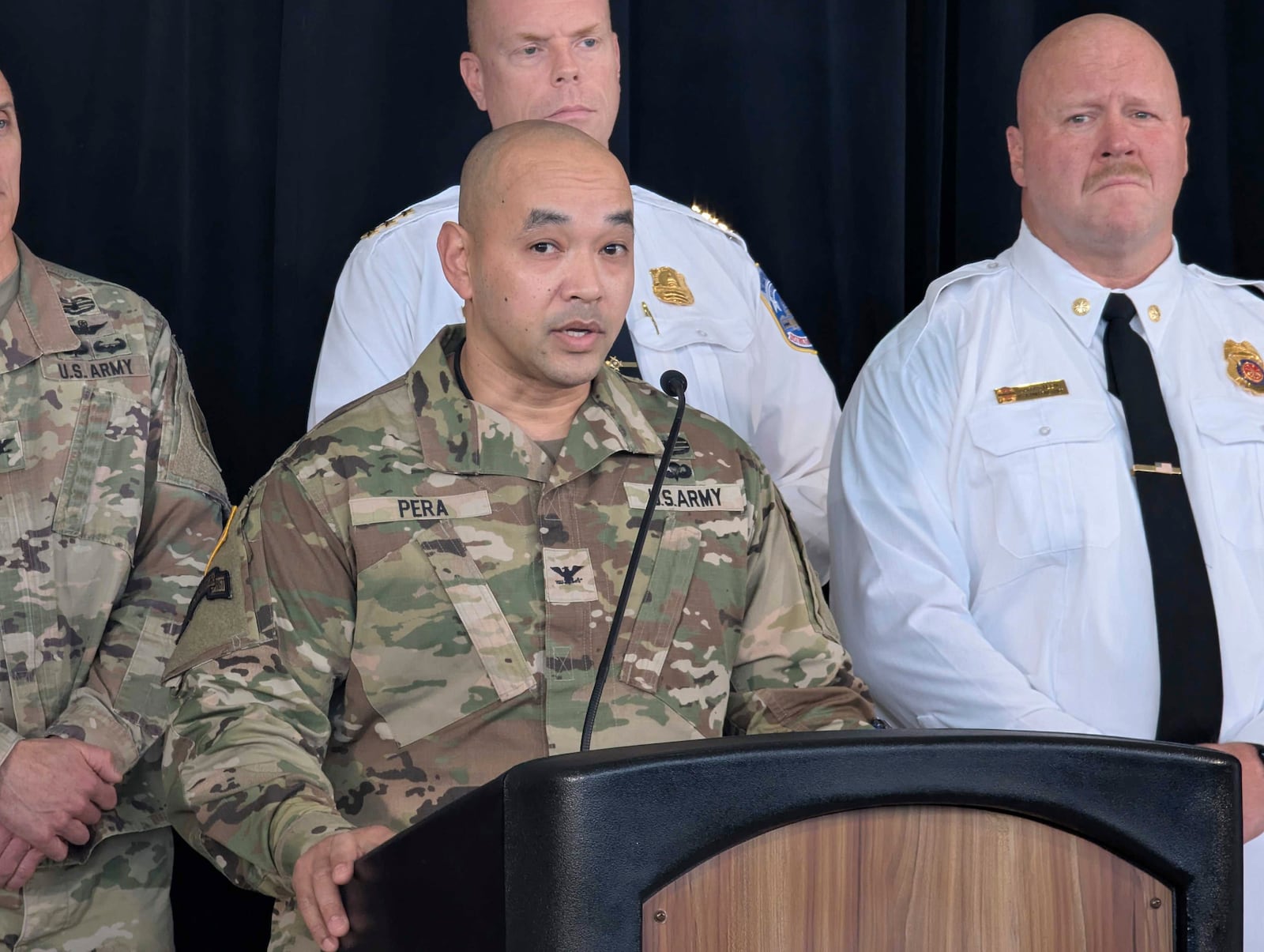 Col. Francis Pera, commander of the U.S. Army Corps of Engineers, speaks as D.C. Fire and EMS Assistant Chief Gary Steen, right, listens during a news conference at Ronald Reagan Washington National Airport Monday, Feb. 3, 2025, in Arlington, Va. (AP Photo/Nathan Ellgren)