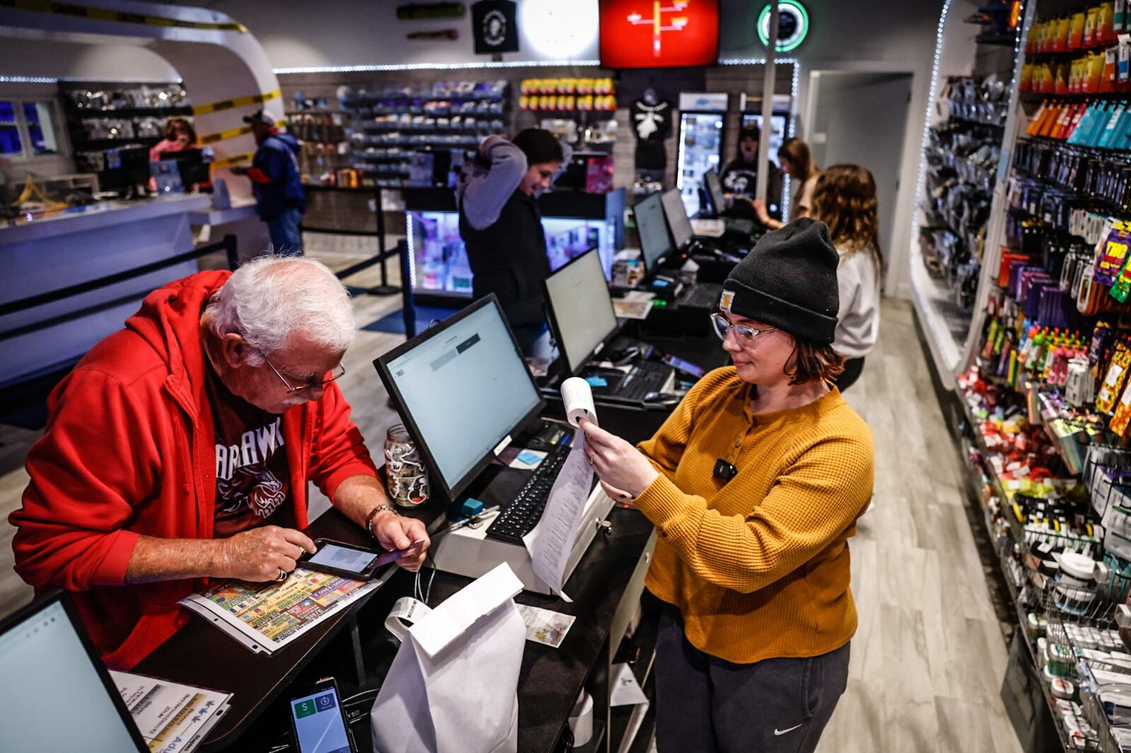 Dean Dearth, left, from Cambridge, Ohio, purchased around $700 worth of recreational marijuana for him and his girlfriend from Amazing Budz in Adrian, Michigan. Cambridge is a little more than four hours' drive to Adrian and would like to see Ohio pass issue 2 that would legalize recreation marijuana in Ohio. JIM NOELKER/STAFF