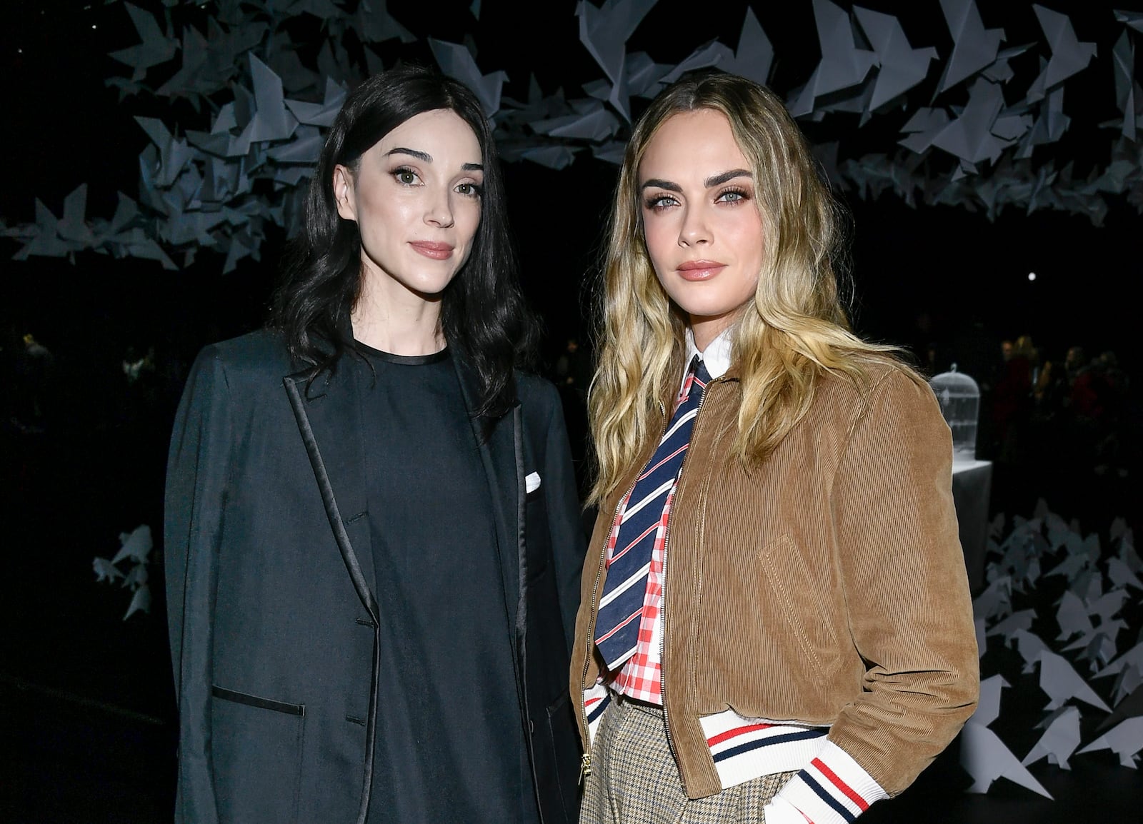 St. Vincent, left, and Cara Delevingne attend the Thom Browne Fall/Winter 2025 fashion show as part of New York Fashion Week on Tuesday, Feb. 11, 2025, at The Shed in New York. (Photo by Evan Agostini/Invision/AP)