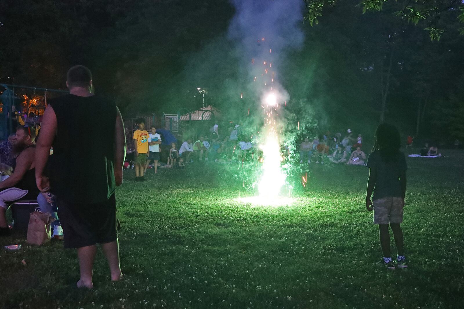 Hundreds of people gathered in Veteran's Park waiting for the 2022 Buck Creek Boom fireworks show to start, with some of them lighting fireworks of their own. BILL LACKEY/STAFF