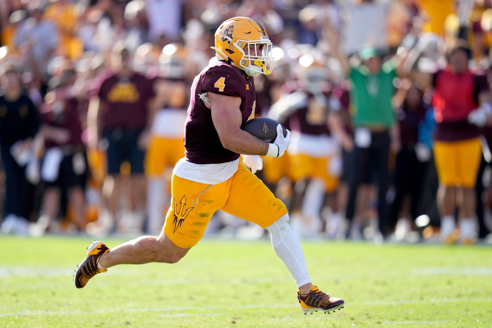 Arizona State running back Cam Skattebo runs for a touchdown against BYU during the first half of an NCAA college football game Saturday, Nov. 23, 2024, in Tempe, Ariz. (AP Photo/Ross D. Franklin)