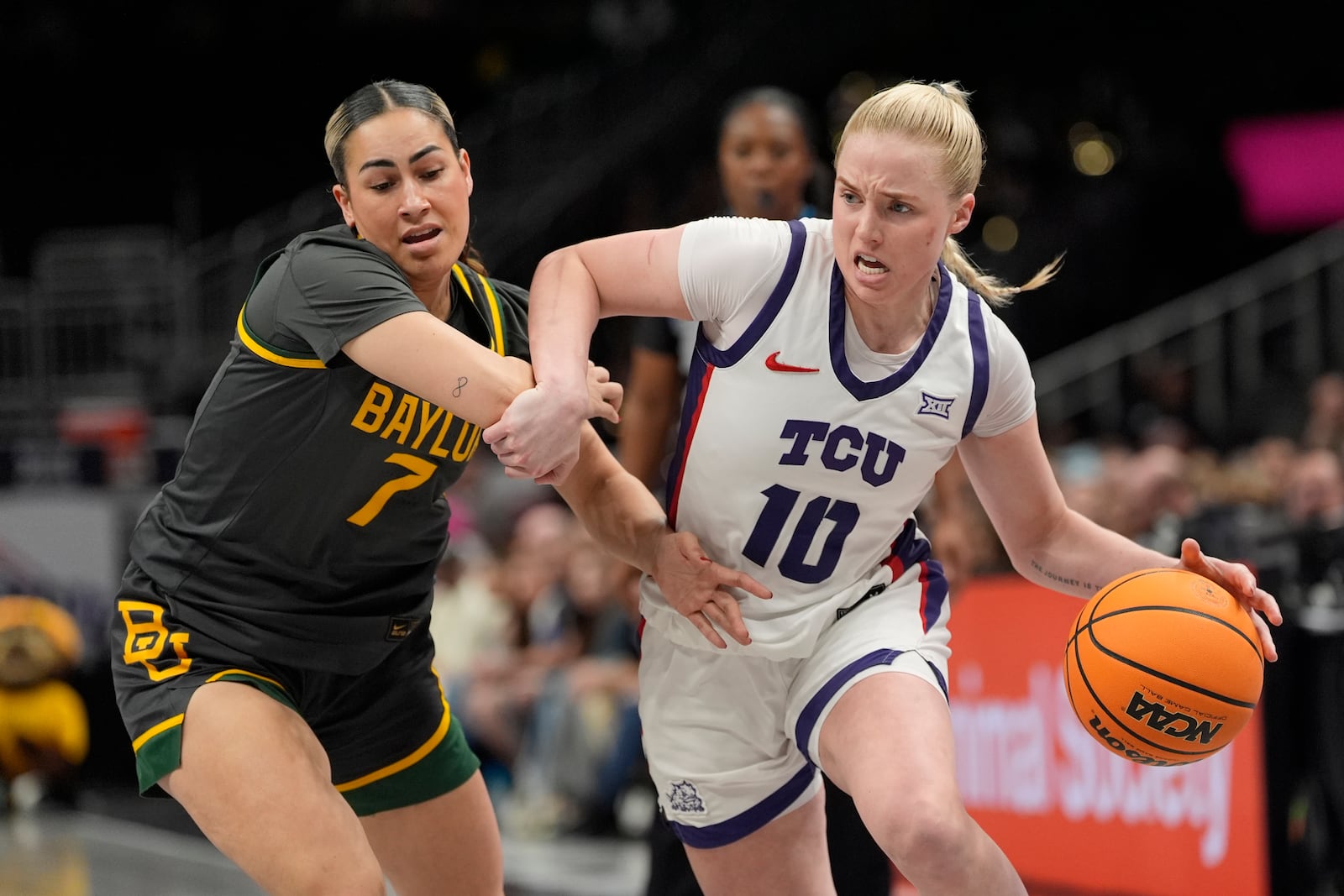 TCU guard Hailey Van Lith (10) drives past Baylor guard Waiata Jennings (7) during the second half of an NCAA college basketball game for the Big 12 women's tournament championship Sunday, March 9, 2025, in Kansas City, Mo. (AP Photo/Charlie Riedel)