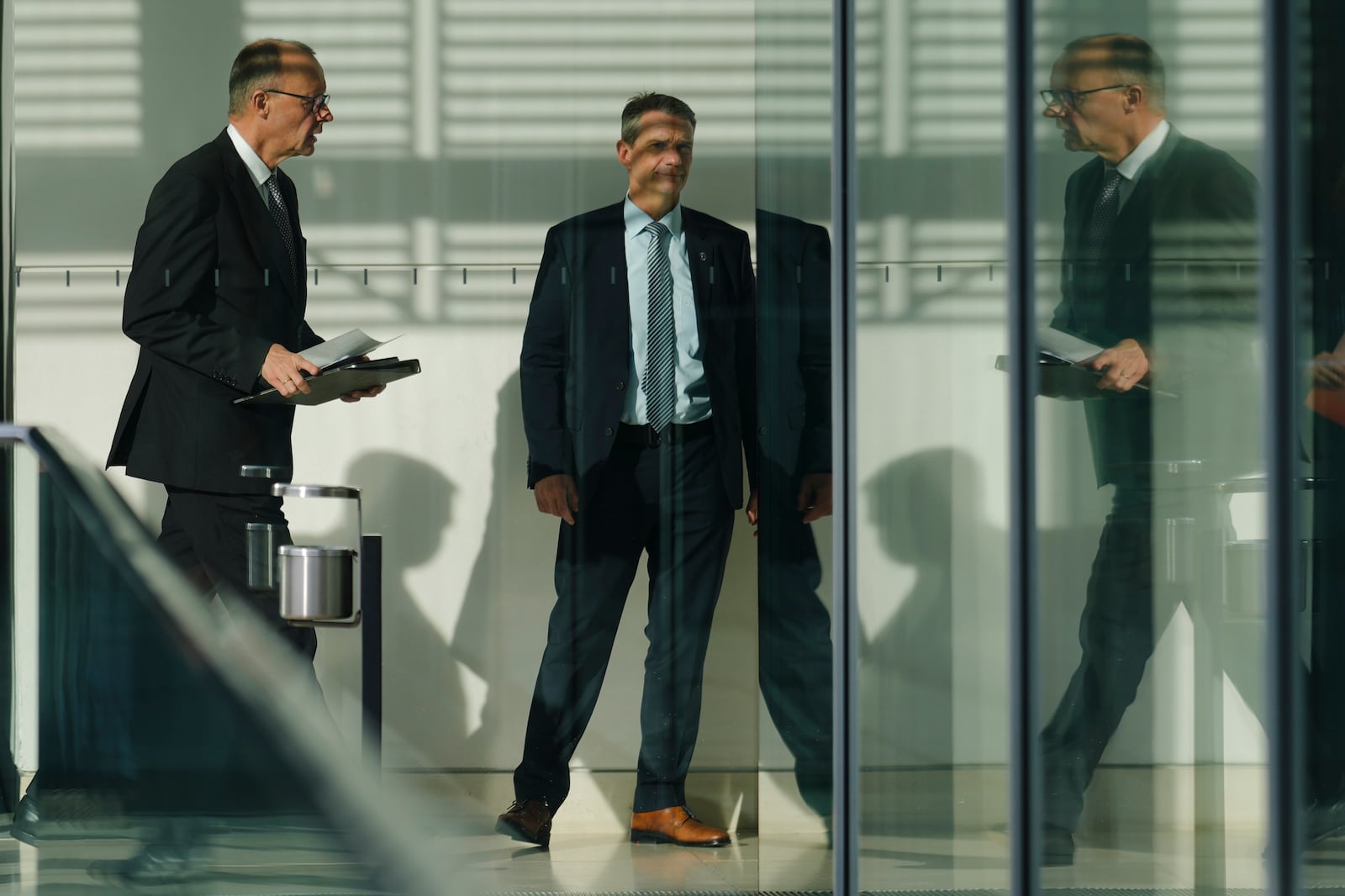 Friedrich Merz, left, leader of the Christian Democratic Union, CDU, arrives for a faction meeting of the Christian Union party's lawmaker at the parliament Bundestag in Berlin, Germany, Tuesday, Feb. 25, 2025. (AP Photo/Markus Schreiber)