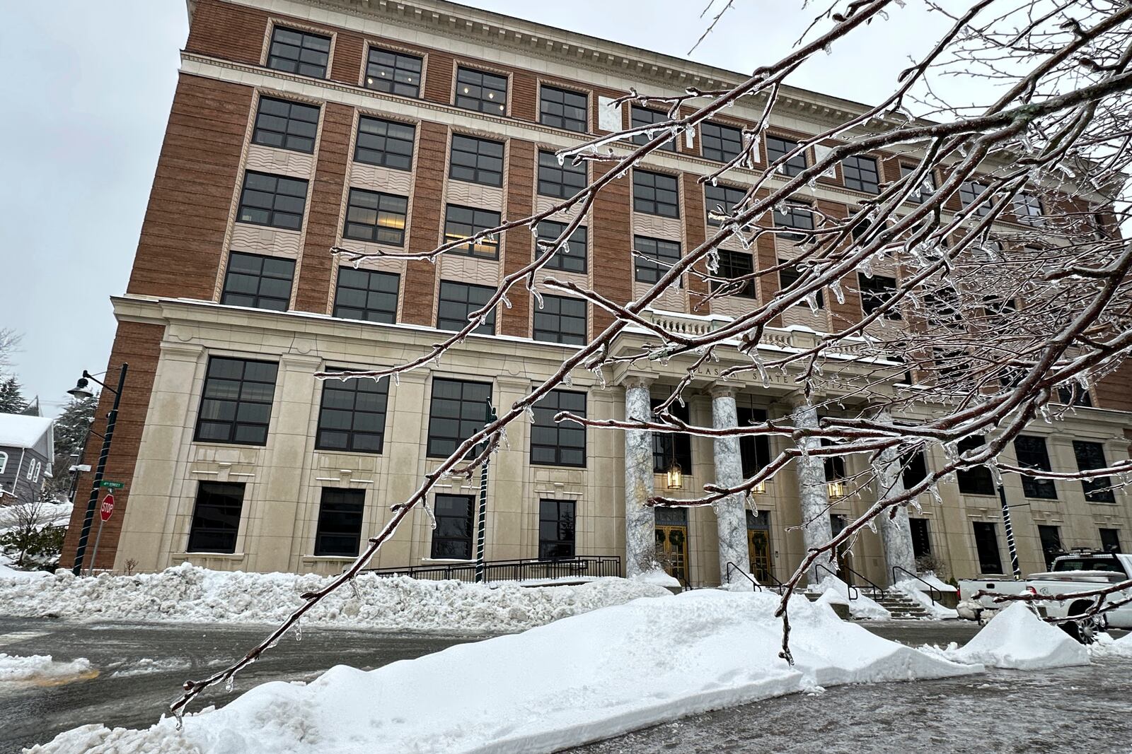 Ice encases branches on a tree in front of the state Capitol on Monday, Dec. 2, 2024, in Juneau, Alaska, after the city was hit by heavy snow and freezing rain. (AP Photo/Becky Bohrer)