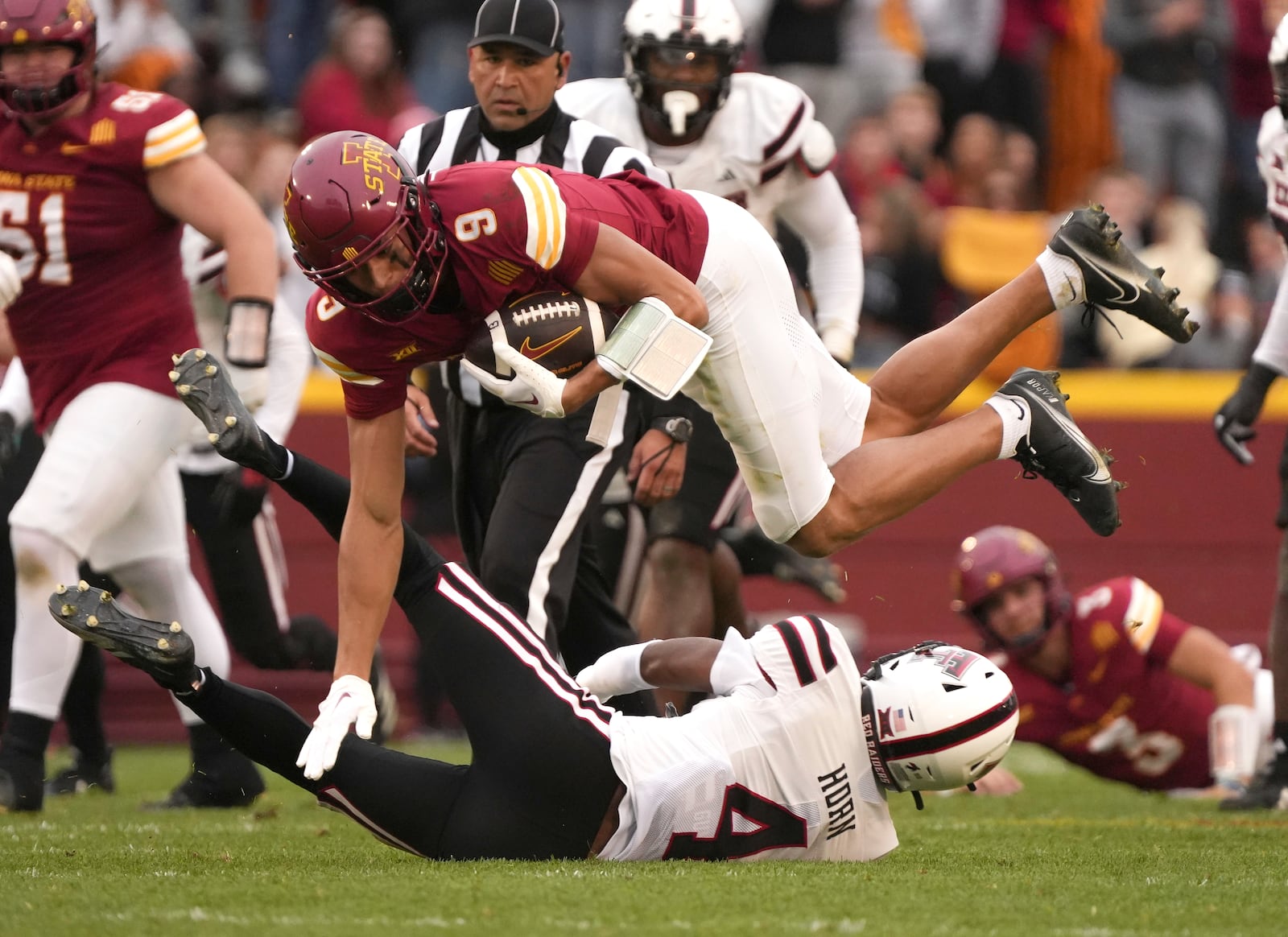 Iowa State wide receiver Jayden Higgins (9) is tripped by Texas Tech defensive back Maurion Horn (4) during the first half of an NCAA college football game, Saturday, Nov. 2, 2024, in Ames, Iowa. (AP Photo/Bryon Houlgrave)