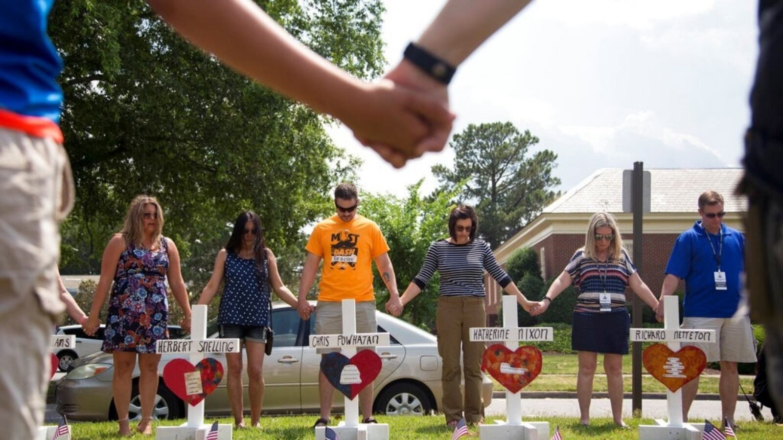 Virginia Beach Shooting
Image ID : 19153856040737
Community members hold hands and pray around the 12 crosses at the memorial located by Building 11 of the Municipal Center, Sunday, June 2, 2019, in Virginia Beach, Va. Twelve crosses were placed at the memorial to honor the 12 victims of the mass shooting that took place at the Virginia Beach Municipal Center days earlier. 