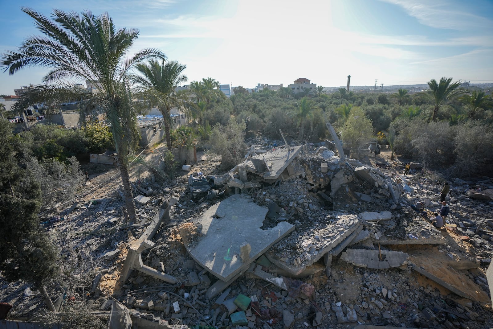 Palestinians look at home destroyed by an Israeli strike late Saturday in Deir al-Balah Sunday, Dec. 22, 2024. At least eight people were killed according to the hospital which received the bodies.(AP Photo/Abdel Kareem Hana)