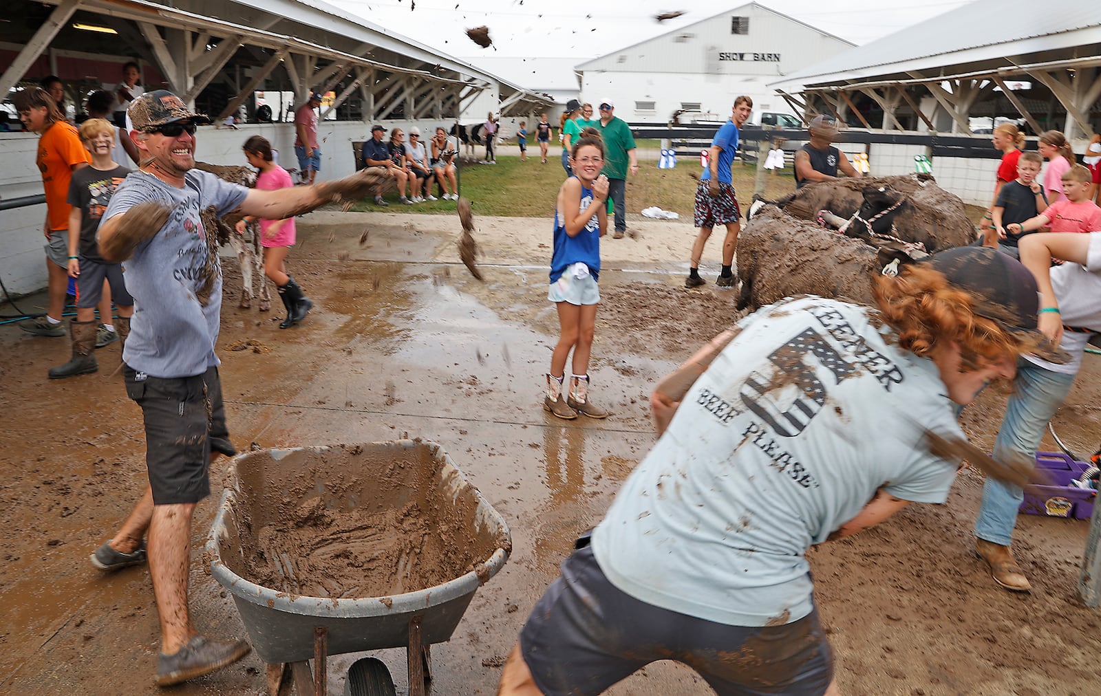 John Balzer, left, and Simon Black started throwing mud on each other after putting mud on the cows before the Junior Fair Dairy Grooming Contest Thursday, July 27, 2023 at the Clark County Fair. BILL LACKEY/STAFF