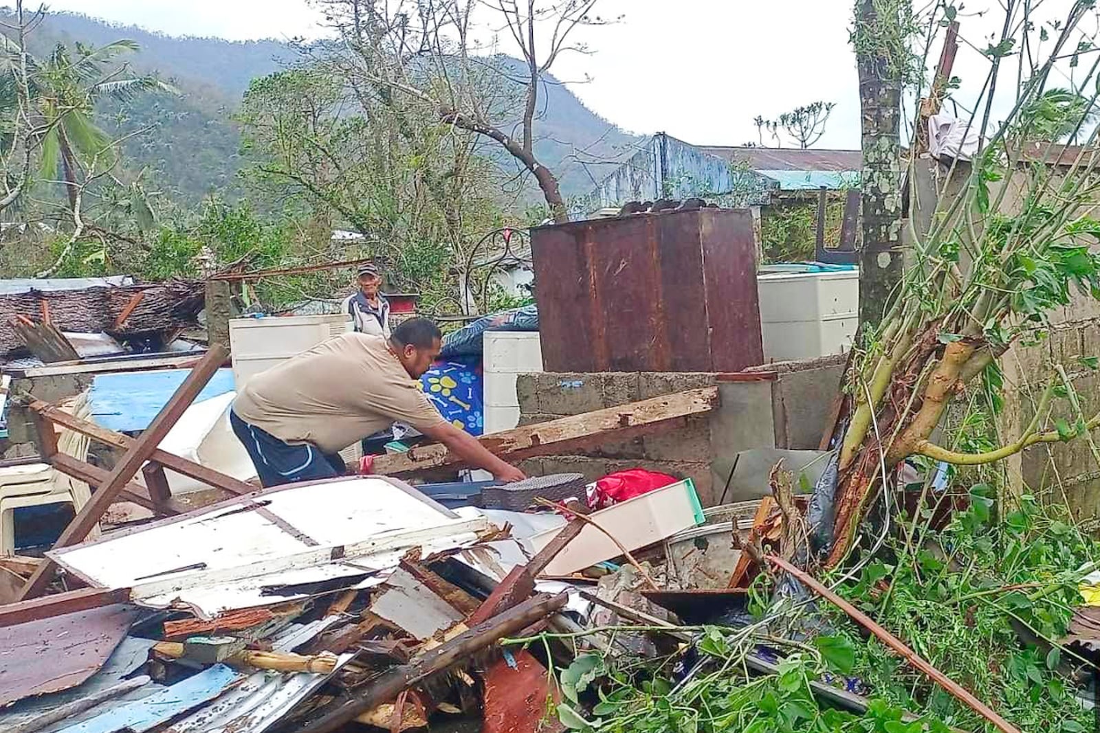 In this photo provided by the MDRRMO Viga Catanduanes, a resident recovers belongings from their damaged homes caused by Typhoon Man-yi in Viga, Catanduanes province, northeastern Philippines Sunday, Nov. 17, 2024. (MDRRMO Viga Catanduanes via AP)