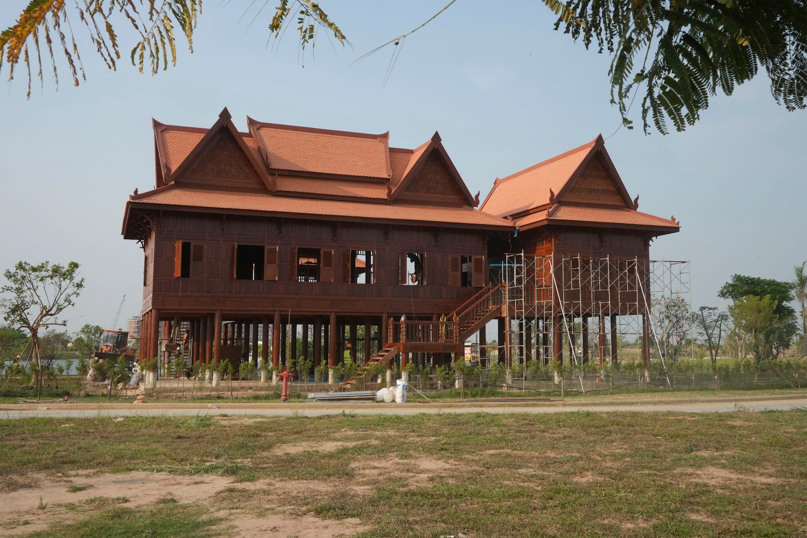 A Cambodian symbolizing of millionaire house places in front of an under a construction of a new airport of Techo International Airport at the outskirts of Phnom Penh Cambodia, Friday, March 21, 2025. (AP Photo/Heng Sinith)