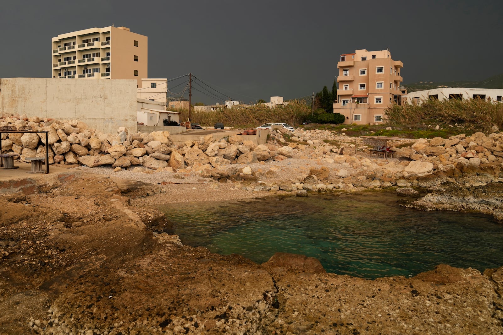 A building, left, in Batroun, northern Lebanon, Saturday, Nov. 2, 2024, where Lebanese officials say a ship captain was taken away by a group of armed men who landed on a coast north of Beirut and they're investigating whether Israel was involved. (AP Photo/Hussein Malla)