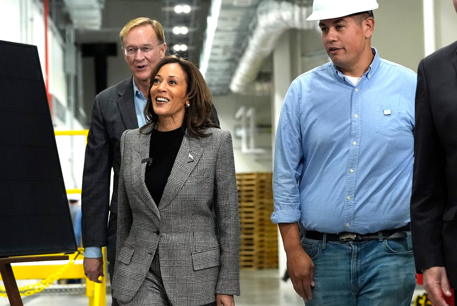 Democratic presidential nominee Vice President Kamala Harris, from second right, tours the Hemlock Semiconductor Next-Generation Finishing facility as Corning Chairman and CEO Wendell Weeks looks on, in Hemlock, Mich., Monday, Oct. 28, 2024. (AP Photo/Jacquelyn Martin)