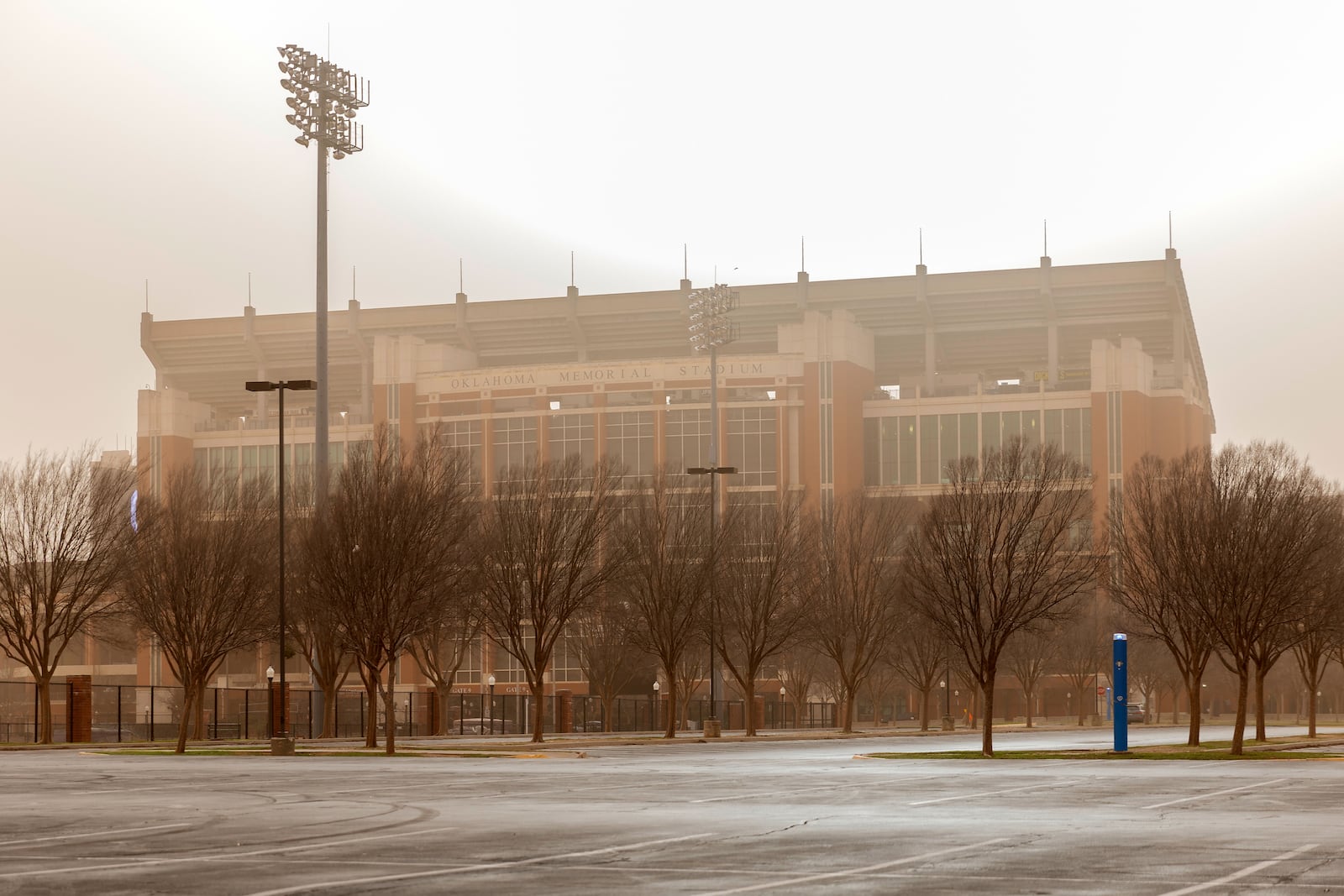 The Oklahoma Memorial Stadium on the campus of the University of Oklahoma is seen covered by dusk and smoke as wildfires spread across Oklahoma on Friday, March 14, 2025. (AP Photo/Alonzo Adams)