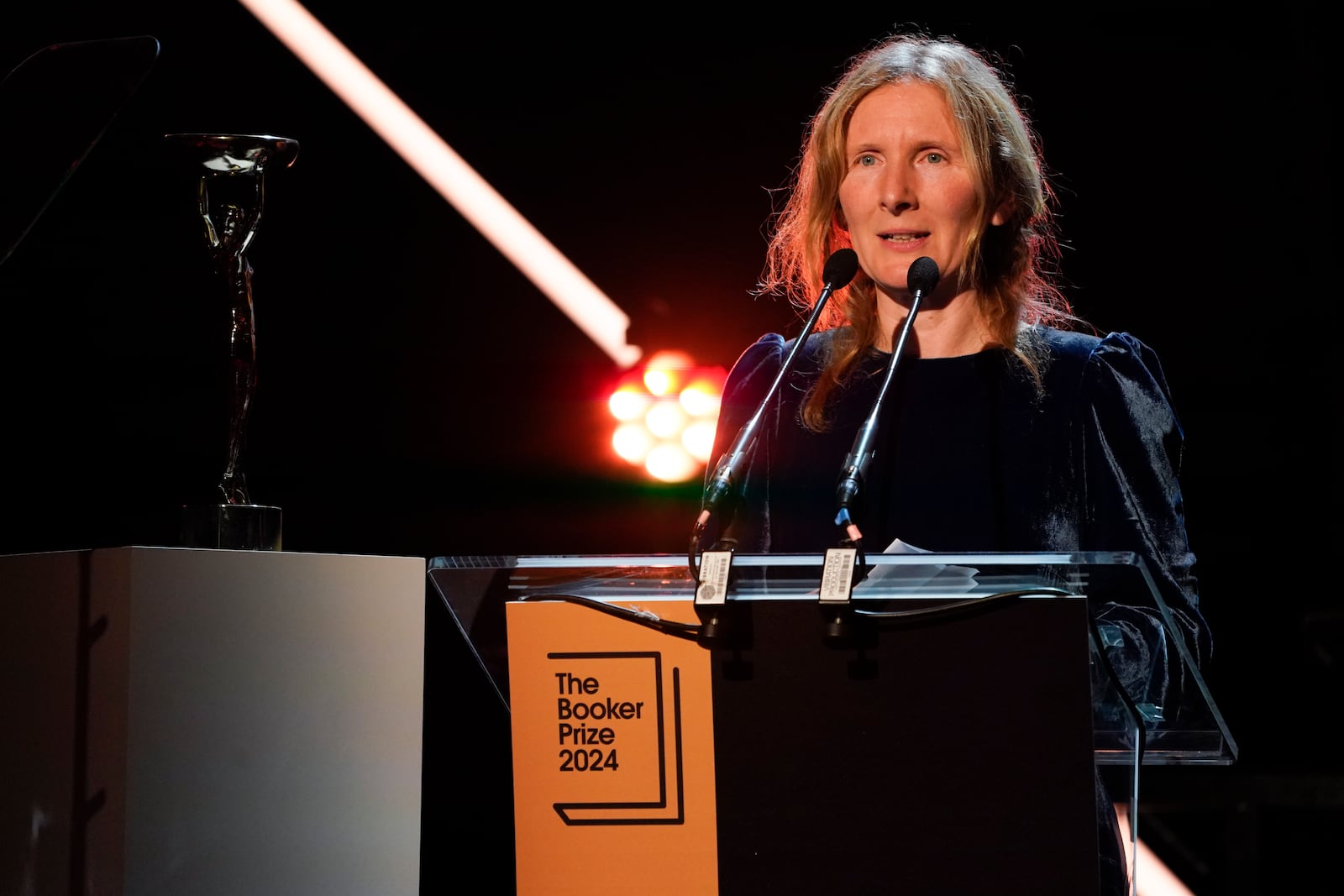 Samantha Harvey speaks on stage after winning the Booker Prize award 2024, in London, Tuesday, Nov. 12, 2024. (AP Photo/Alberto Pezzali)