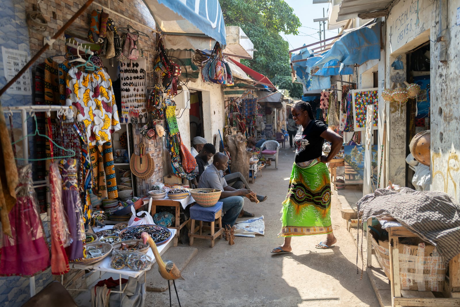 A woman walks through the Soubedioune craft market in Dakar, Senegal, Thursday, Nov. 28, 2024. (AP Photo/Sylvain Cherkaoui)