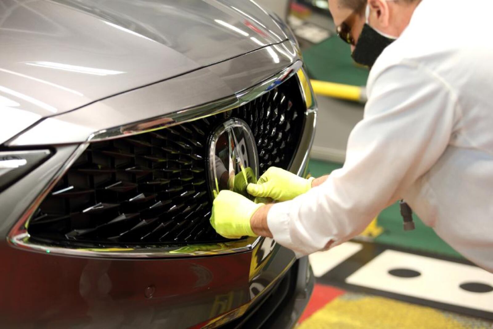 The Acura logo is carefully installed on a completed 2022 Acura MDX at the East Liberty Auto Plant. Acura image