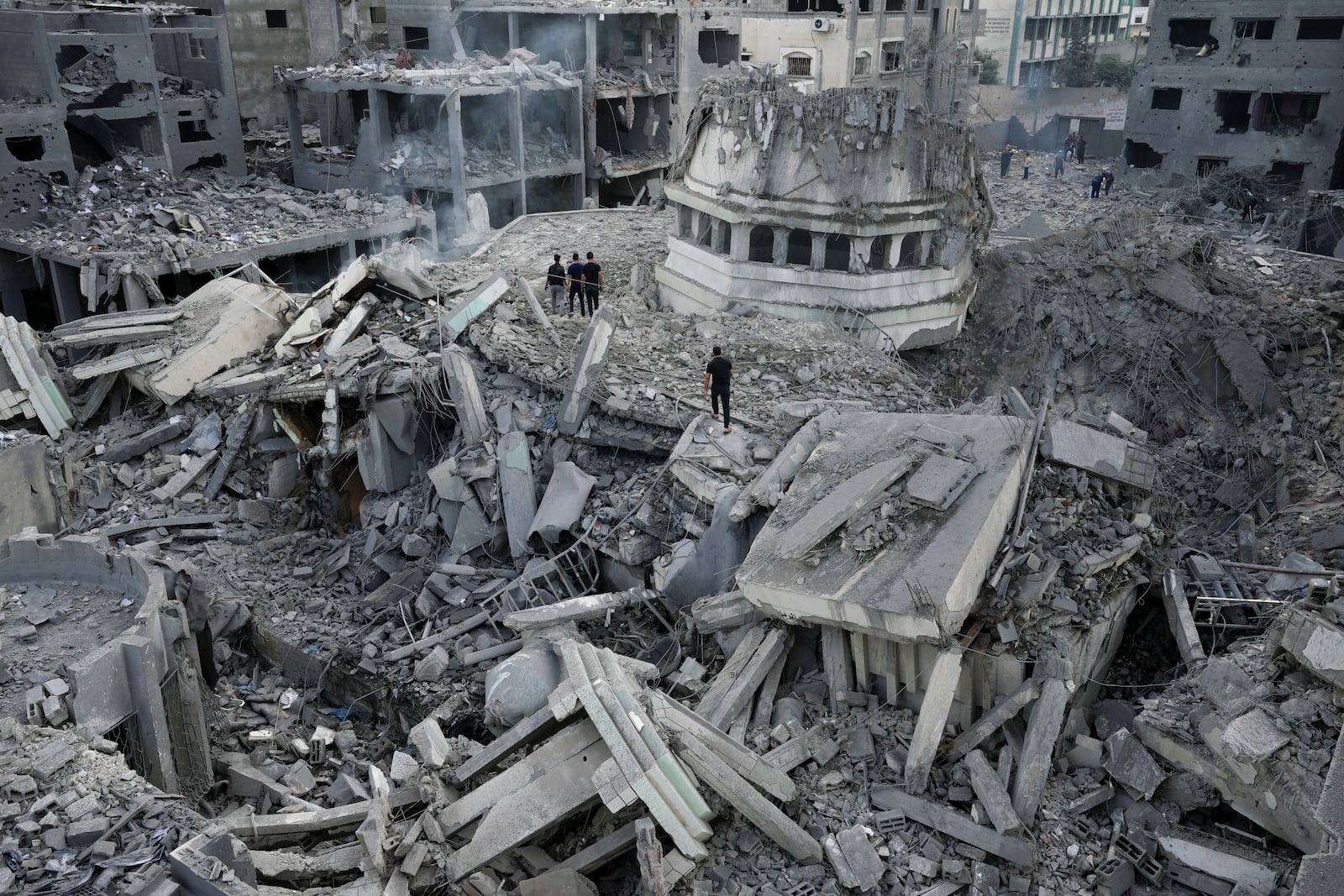 FILE - Palestinians inspect the rubble of the Yassin Mosque after it was hit by an Israeli airstrike at Shati refugee camp in Gaza City, on Oct. 9, 2023. (AP Photo/Adel Hana, File)