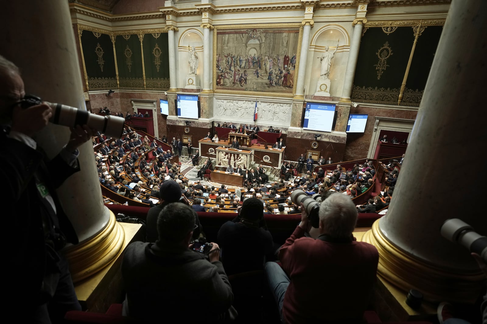 Press photographers focus on French Prime Minister Francois Bayrou delivering his general policy speech, Tuesday, Jan. 14, 2025 at the National Assembly in Paris. (AP Photo/Thibault Camus)