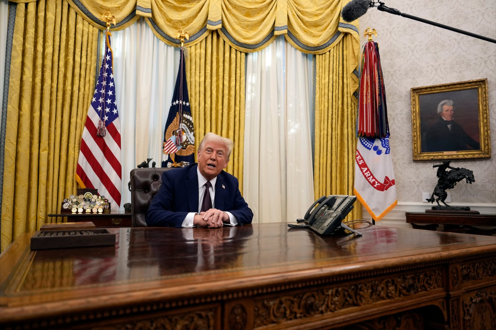 FILE - President Donald Trump answers questions from reporters as he signs an executive orders in the Oval Office of the White House, Jan. 23, 2025, in Washington. (AP Photo/Ben Curtis, File)