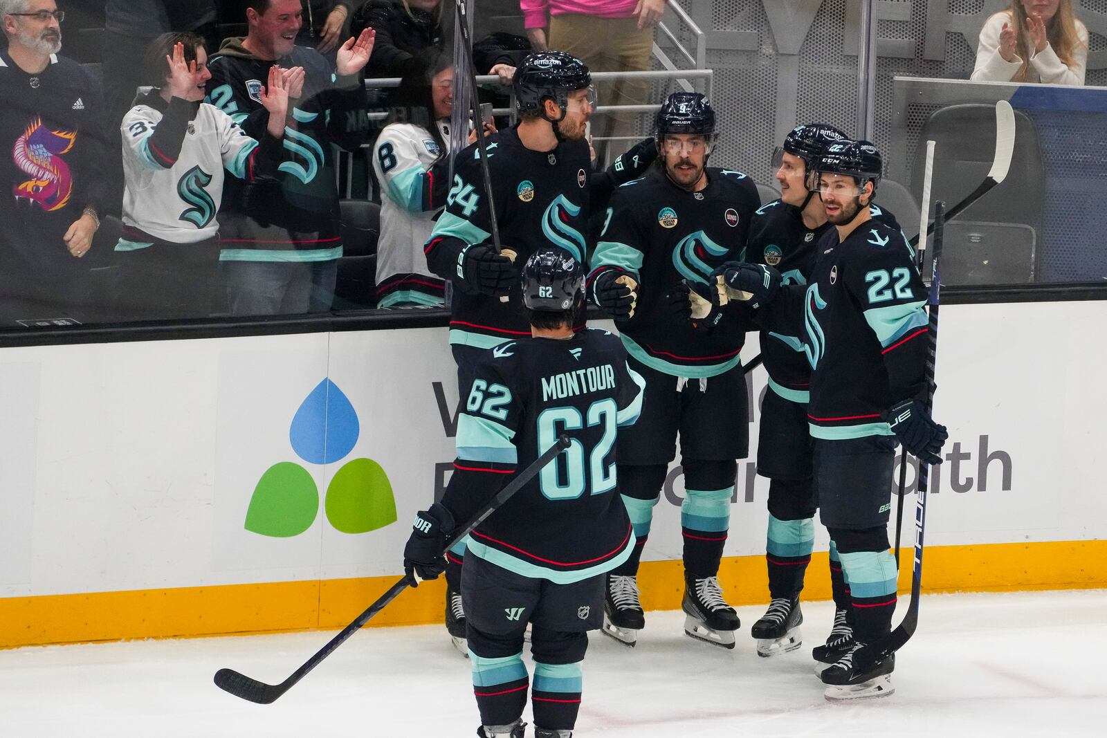 Seattle Kraken center Chandler Stephenson, third from left, celebrates his goal against the San Jose Sharks with teammates Brandon Montour (62), Jamie Oleksiak (24), Eeli Tolvanen and Oliver Bjorkstrand (22) during the first period of an NHL hockey game Thursday, Jan. 30, 2025, in Seattle. (AP Photo/Lindsey Wasson)