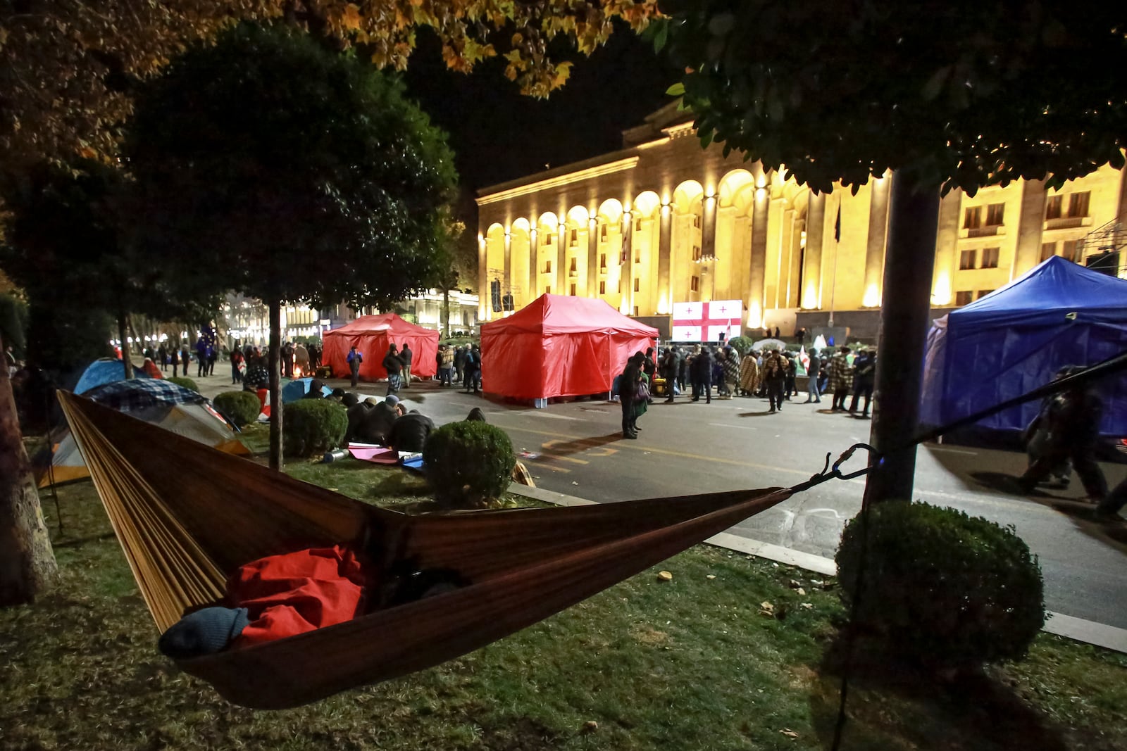 Protesters gather in front of the Parliament's building during a rally to demand new parliamentary elections in the country, in Tbilisi, Georgia, Monday, Nov. 25, 2024. (AP Photo/Zurab Tsertsvadze)