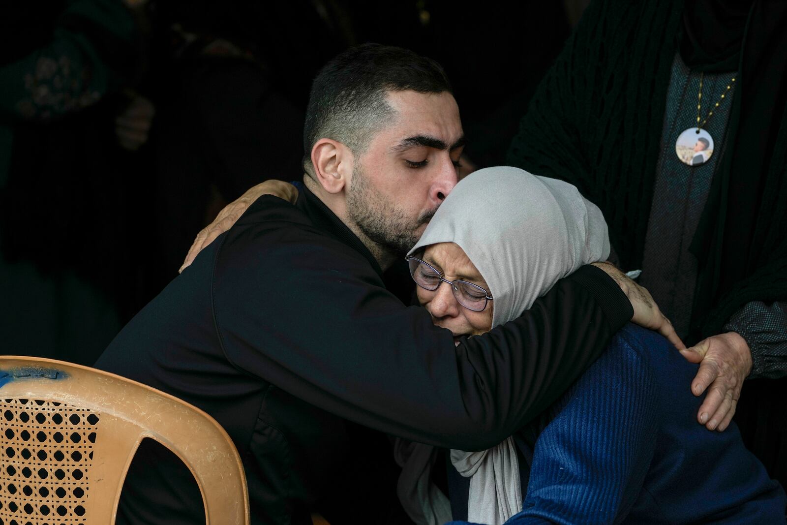 Mourners comfort each other during the funeral of Ahmad Nimer Al-Shaib after he was killed during an Israeli military operation in Jenin, in the West Bank village of Bruqin, Wednesday, Jan. 22, 2025. (AP Photo/Majdi Mohammed)