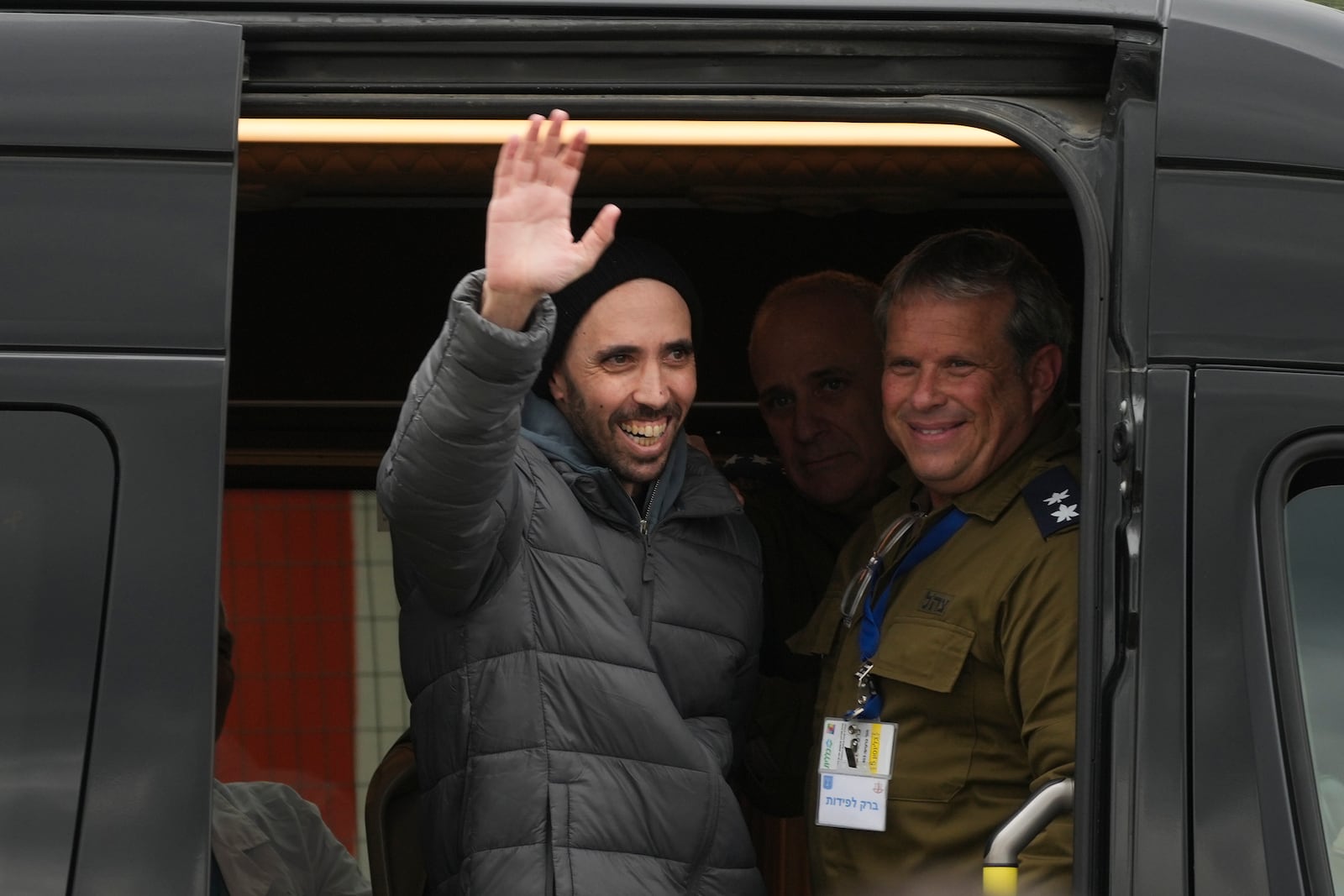 Freed Israeli hostage Tal Shoham waves from a van as he arrives to the Beilinson hospital in Petah Tikva, Israel, Ssturday, Feb. 22, 2025. After he was release from Hamas captivity in the Gaza strip. (AP Photo/Ohad Zwigenberg)