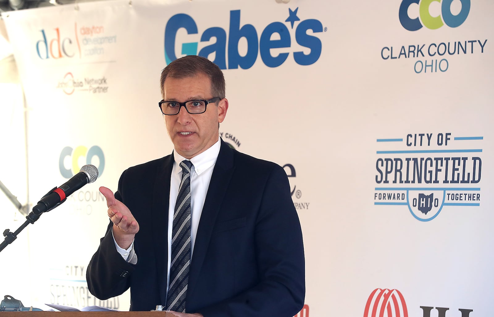 Jason Mazzola, president and CEO of Gabe's, speaks during a groundbreaking ceremony for Gabe's $77.5 million distribution center in Springfield. BILL LACKEY/STAFF