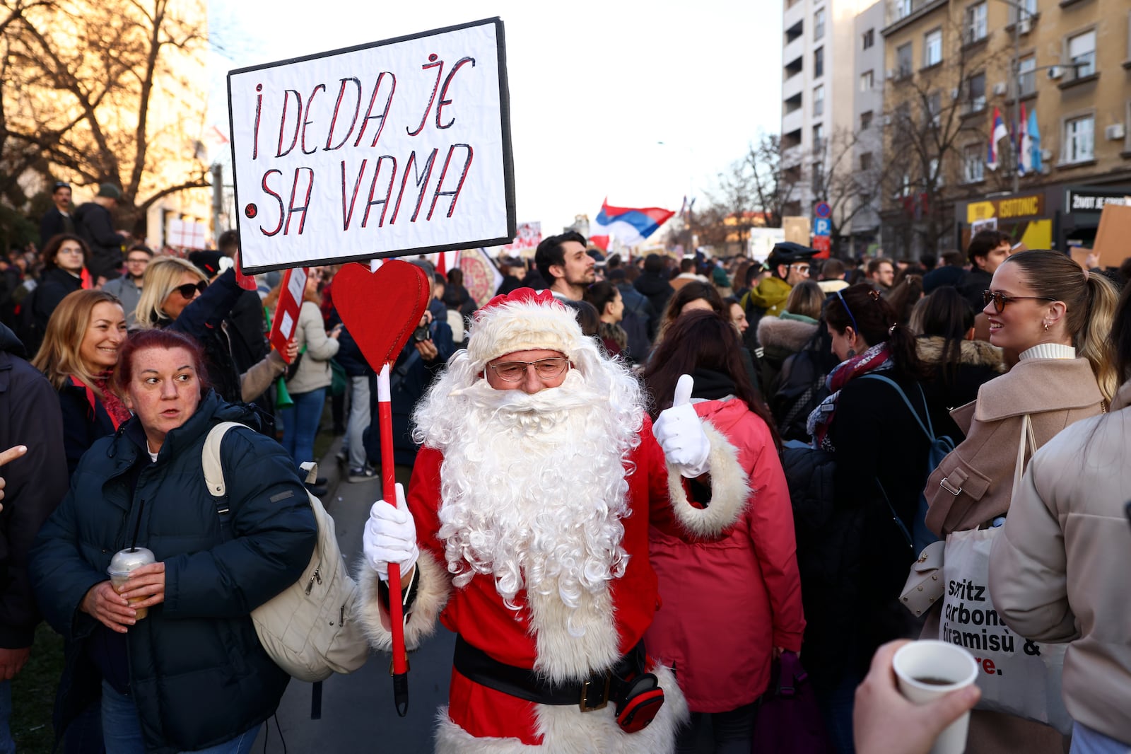 A man dressed as Santa Claus joins a protest over the collapse of a concrete canopy that killed 15 people more than two months ago, in Novi Sad, Serbia, Saturday, Feb. 1, 2025. (AP Photo/Armin Durgut)