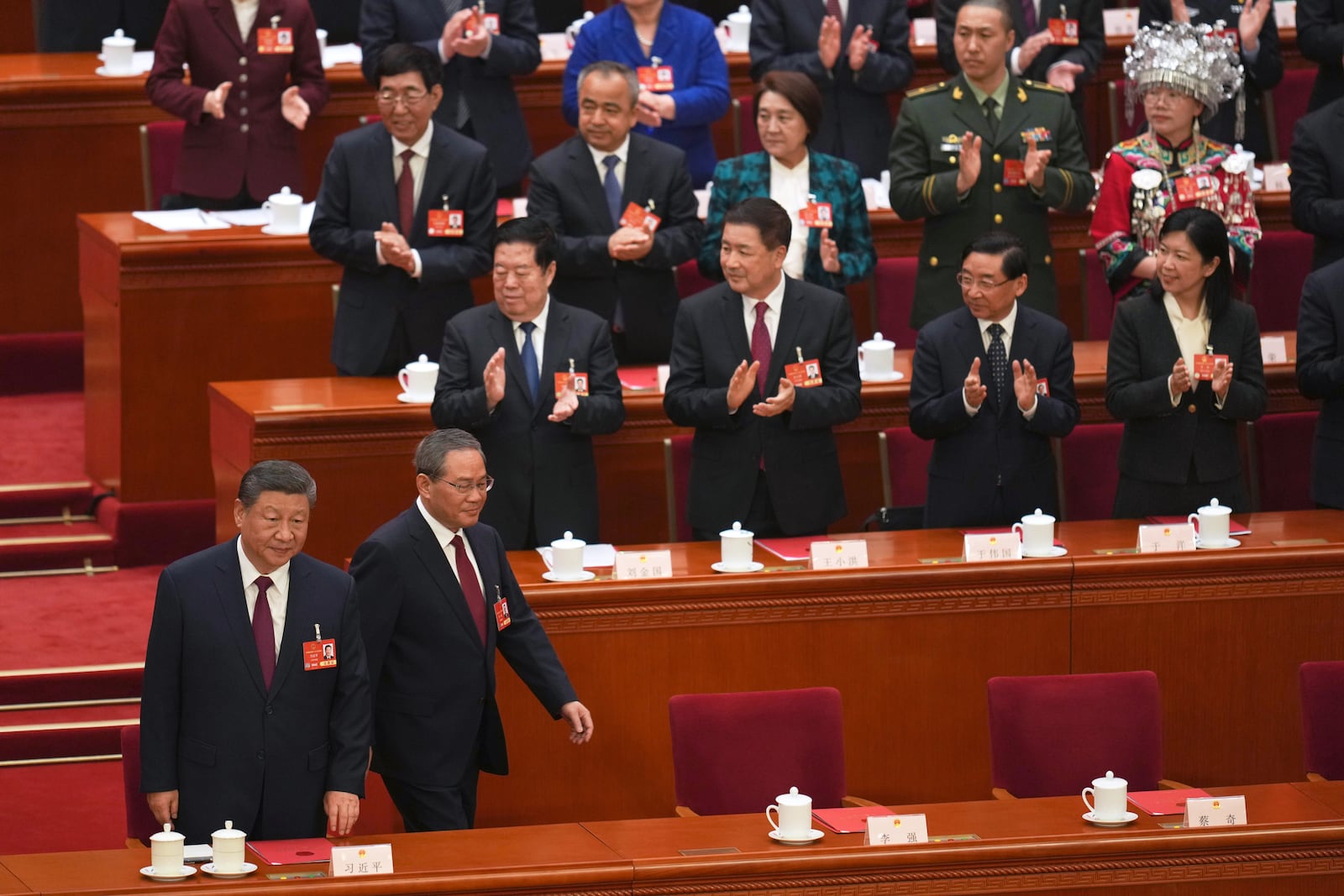 Chinese President Xi Jinping, left, and Chinese Premier Li Qiang arrive for the closing ceremony of the National People's Congress held at the Great Hall of the People in Beijing, Tuesday, March 11, 2025. (AP Photo/Ng Han Guan)