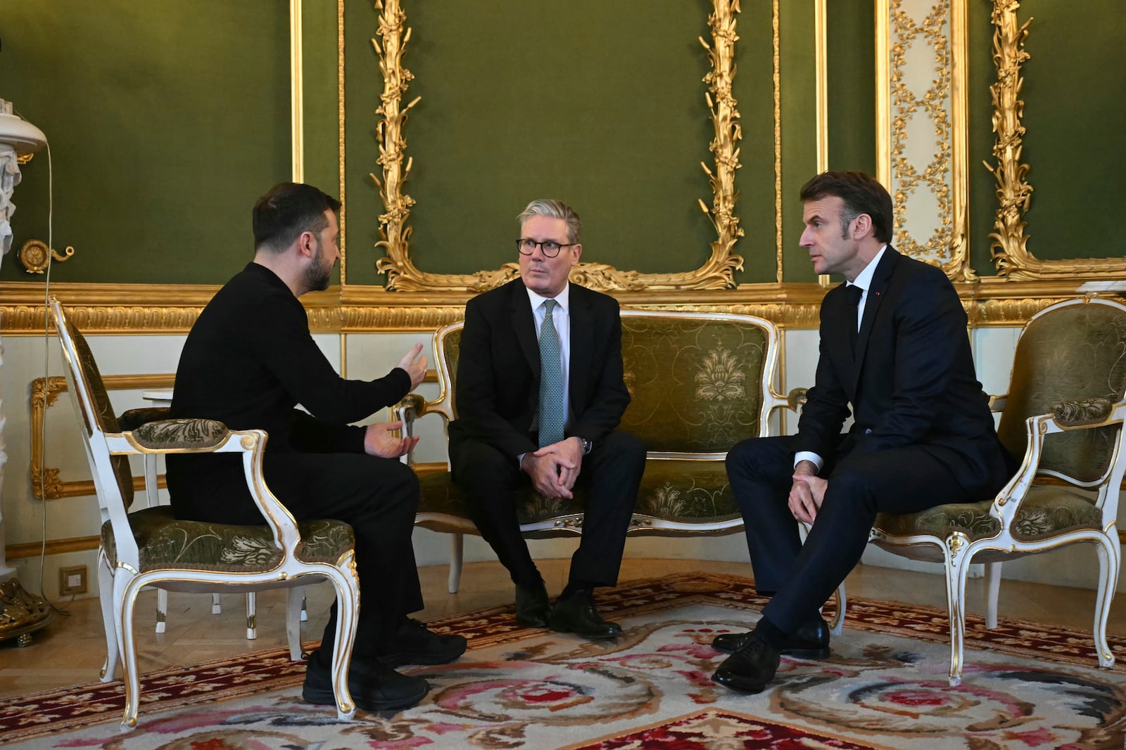 Britain's Prime Minister Keir Starmer, center, Ukraine's President Volodymyr Zelenskyy, left, and France's President Emmanuel Macron meet during the European leaders' summit to discuss Ukraine, hosted by Britain's Prime Minister Keir Starmer, at Lancaster House, London, Sunday March 2, 2025. (Justin Tallis/Pool via AP)