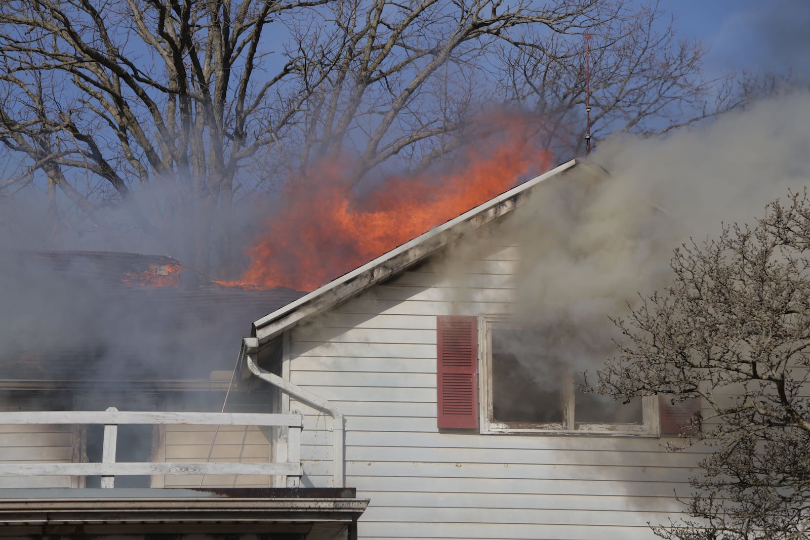 Heavy smoke and flames were reported at a house on Milton Carlisle Road in New Carlisle on Friday, March 14, 2025. BILL LACKEY/STAFF