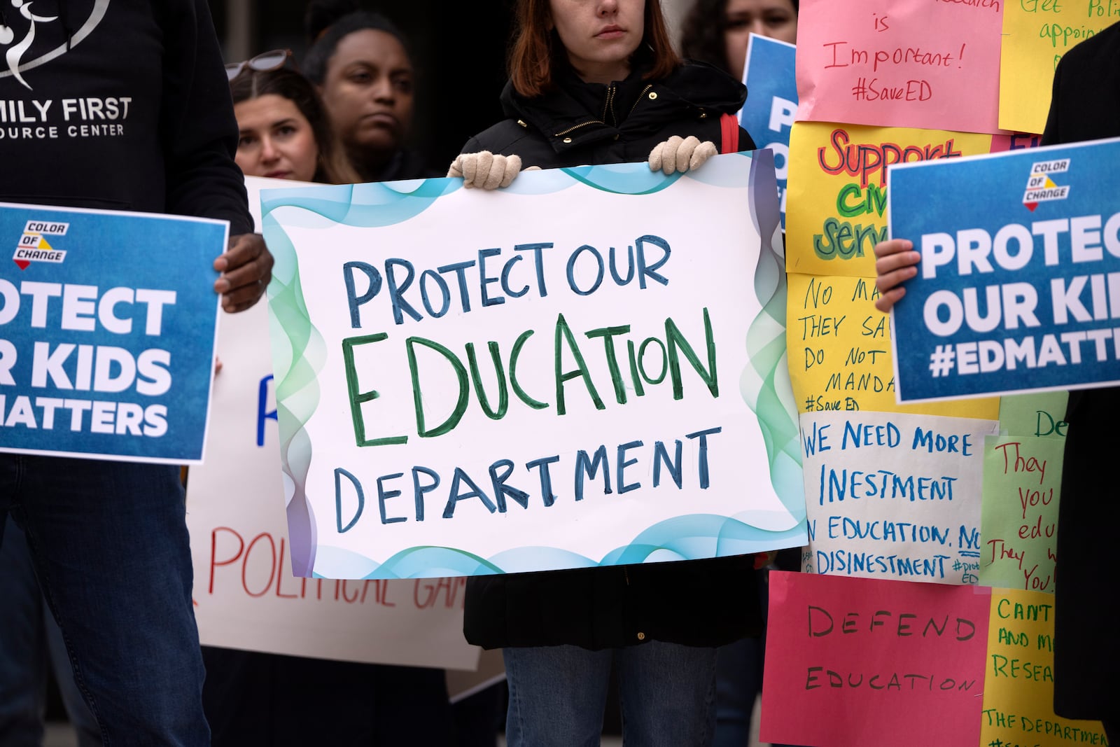 Protestors gather during a demonstration at the headquarters of the Department of Education, Friday, March 14, 2025, in Washington. (AP Photo/Mark Schiefelbein)