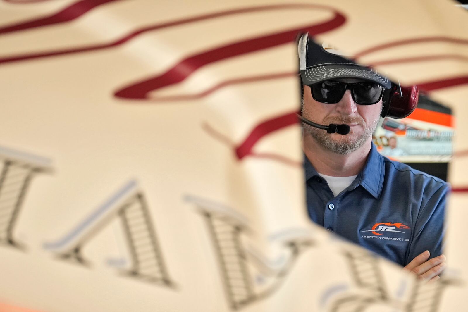 Former driver Dale Earnhardt Jr., watches as a crew works on Justin Allgaier's car during a practice for the NASCAR Daytona 500 auto race Wednesday, Feb. 12, 2025, at Daytona International Speedway in Daytona Beach, Fla. (AP Photo/Chris O'Meara)