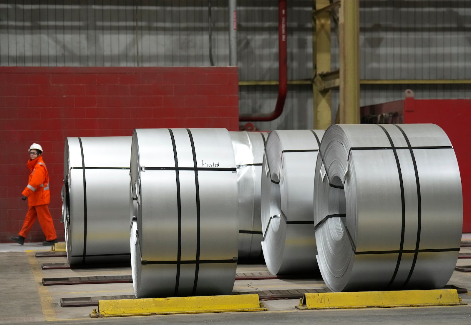 A steel worker works at the ArcelorMittal Dofasco steel plant in Hamilton, Ontario, Wednesday, March 12, 2025. (Nathan Denette/The Canadian Press via AP)