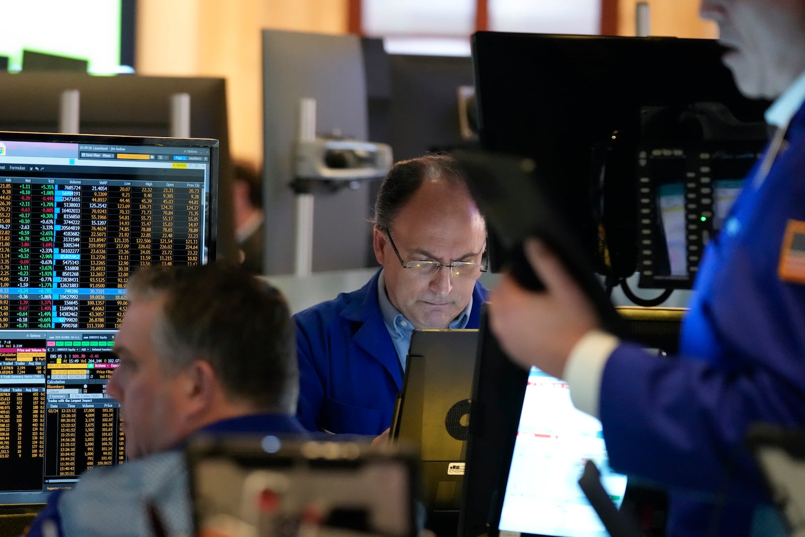 People work on the floor at the New York Stock Exchange in New York, Monday, Feb. 24, 2025. (AP Photo/Seth Wenig)