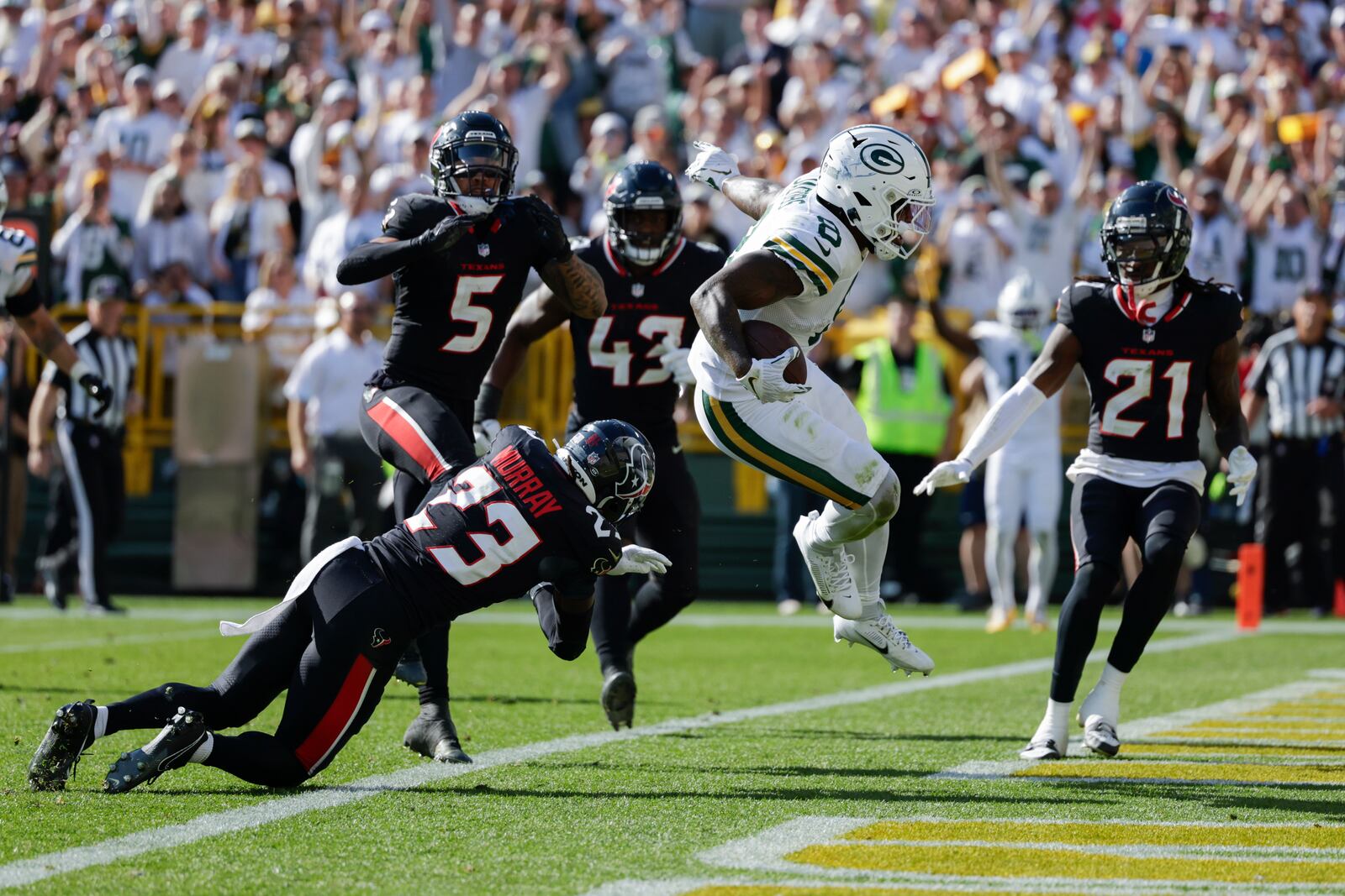 Green Bay Packers running back Josh Jacobs (8) scores a touchdown during the second half of an NFL football game against the Houston Texans, Sunday, Oct. 20, 2024, in Green Bay, Wis. (AP Photo/Matt Ludtke)