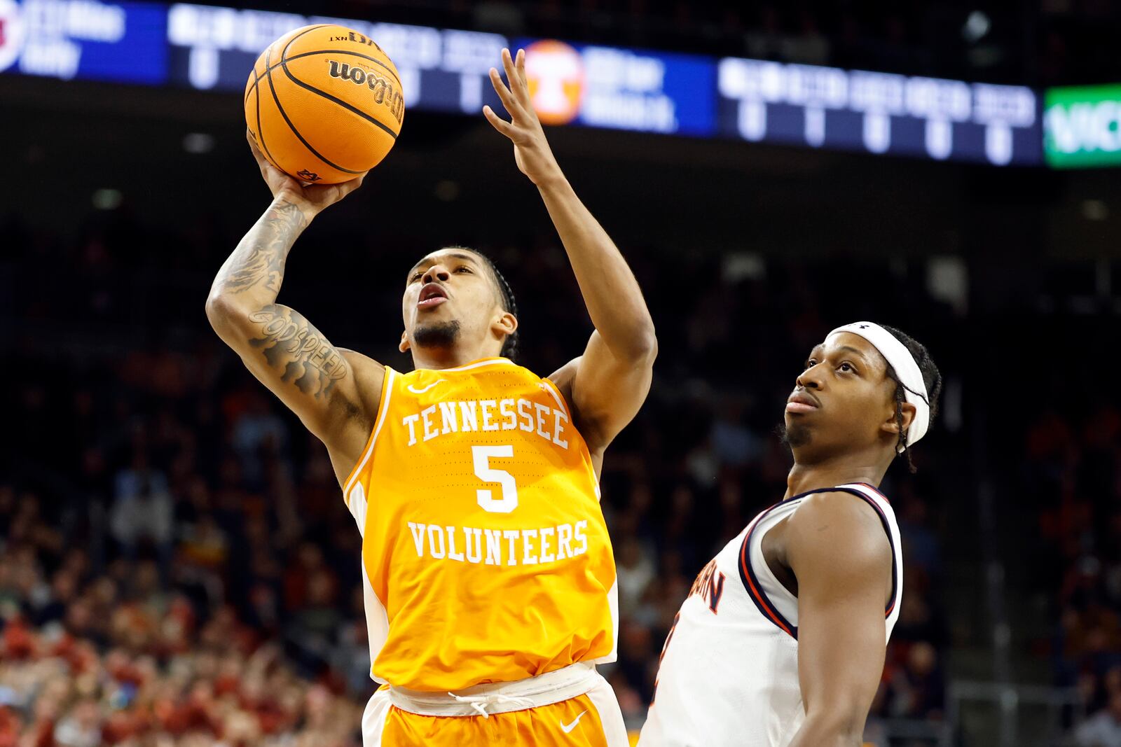 Tennessee guard Zakai Zeigler (5) looks to shoot as Auburn guard Denver Jones, right, defends during the first half of an NCAA college basketball game, Saturday, Jan. 25, 2025, in Auburn. (AP Photo/Butch Dill)