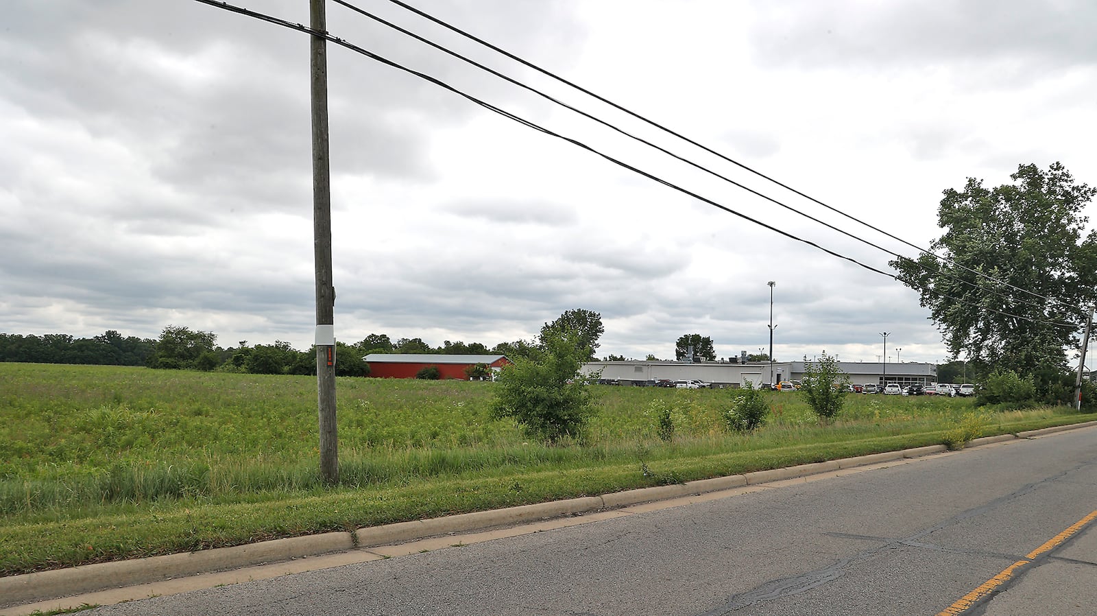 The future site along Ohio 235 of the Reserve at Honey Creek housing development. BILL LACKEY/STAFF