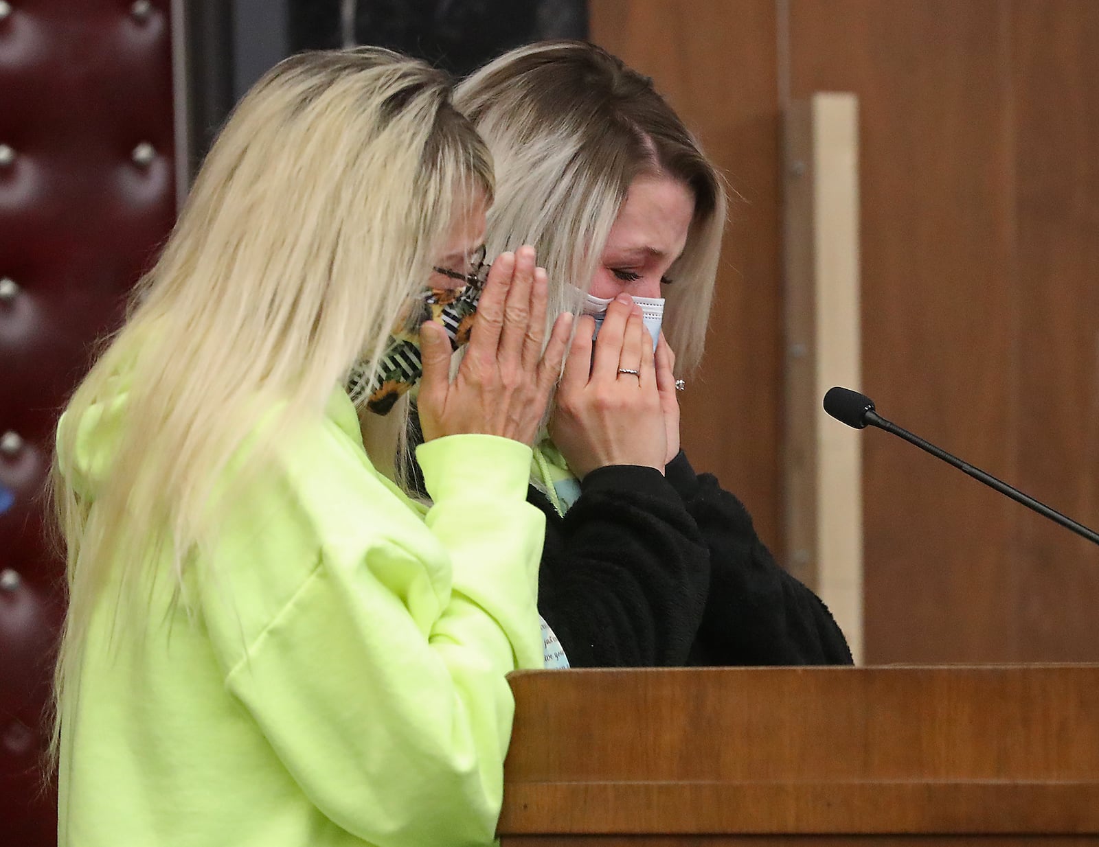 Kim Long, left, the mother of murder victim Whitney Hostler, and Chelsea Hostler, Witney's sister, become emotional as they speak at Rodney Rider's sentencing in Champaign County Common Pleas Court Monday. BILL LACKEY/STAFF