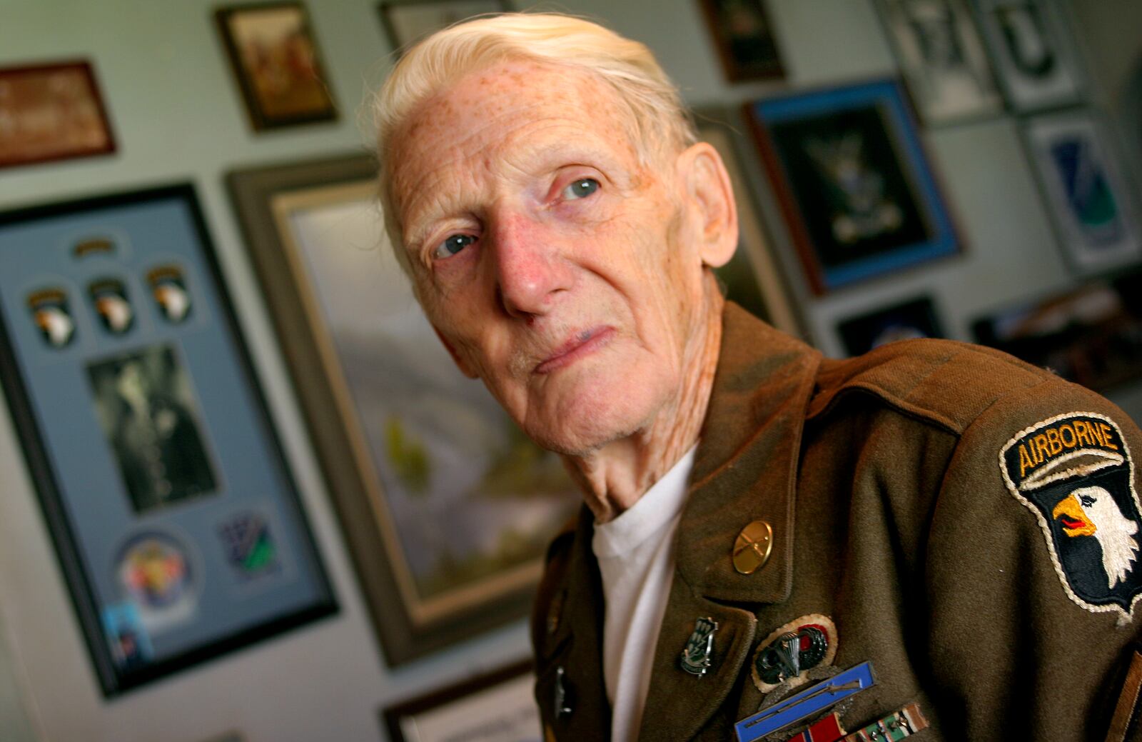 110206---Jim Martin was a member of the 101st Airborne Division on D Day. He and his group jumped 25 miles behind enemy lines the night before the invasion under heavy German artillery fire. He also saw action in Holland, the Battle of the Bulge, and Germany, liberating a concentration camp and Hitler's Bavarian home. He was awarded two Purple Hearts and a Bronze Star. STAFF PHOTO BY BILL REINKE.