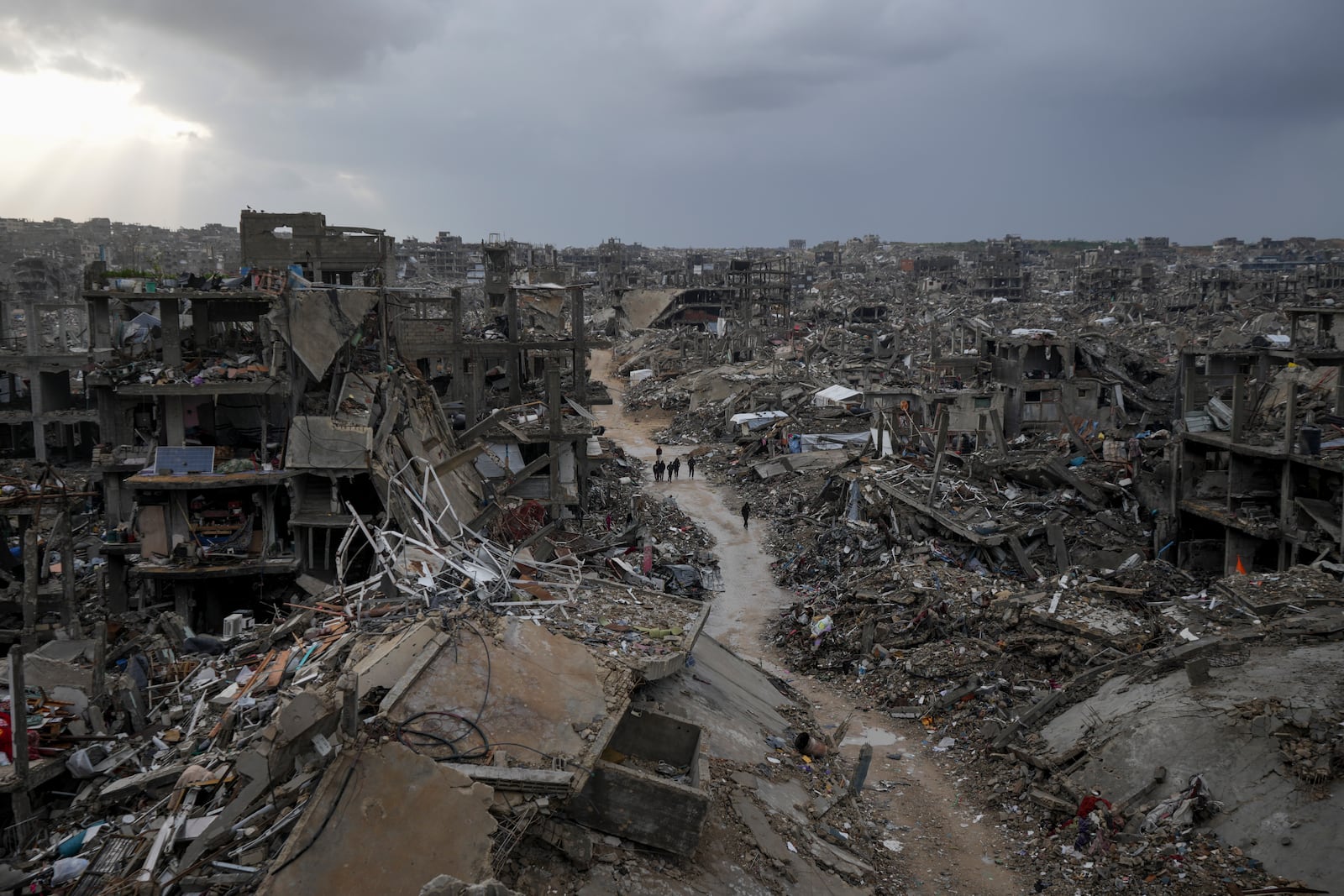 Palestinians walk in the destruction caused by the Israeli air and ground offensive in Jabaliya, Gaza Strip, Thursday, Feb. 6, 2025. (AP Photo/Abdel Kareem Hana)