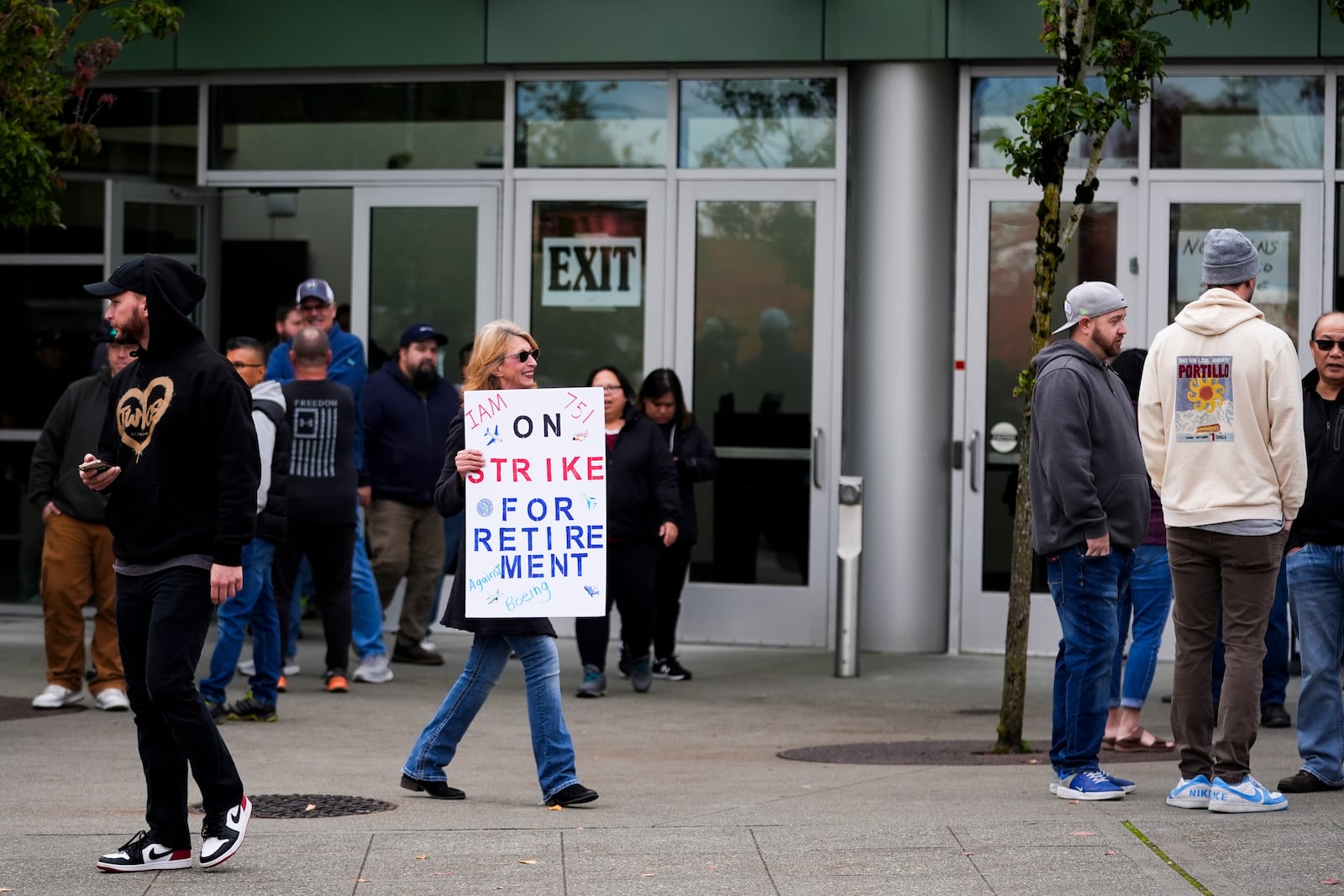 A worker holds a sign as Boeing employees vote on a new contract offer from the company, Wednesday, Oct. 23, 2024, at a voting location in the Angel of the Winds Arena in Everett, Wash. (AP Photo/Lindsey Wasson)