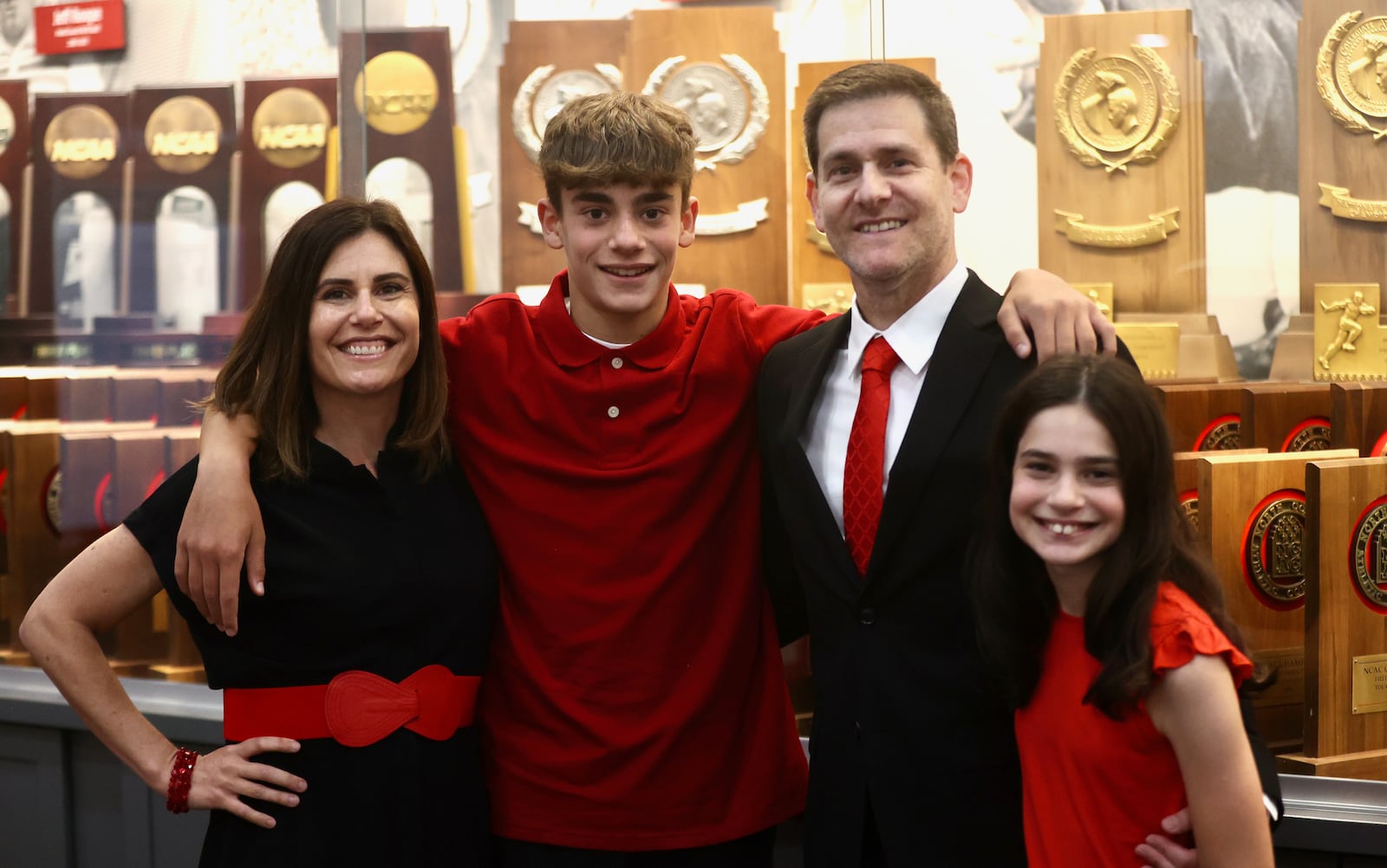 Darren Hertz poses for a photo with his wife Julie and children Brandon and Lexi at Wittenberg after being introduced as men's basketball caoch on Tuesday, Sept. 3, 2024, in Springfield. David Jablonski/Staff