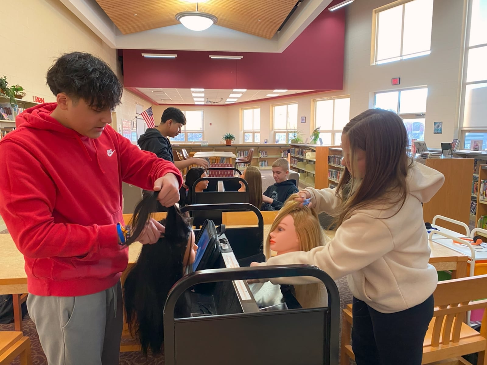 Tecumseh Middle School offers a "Career Cafe" for student to look at different Springfield-Clark Career Technology programs each month during study hall. In this photo, students are braiding hair as part of the cosmetology unit. Contributed