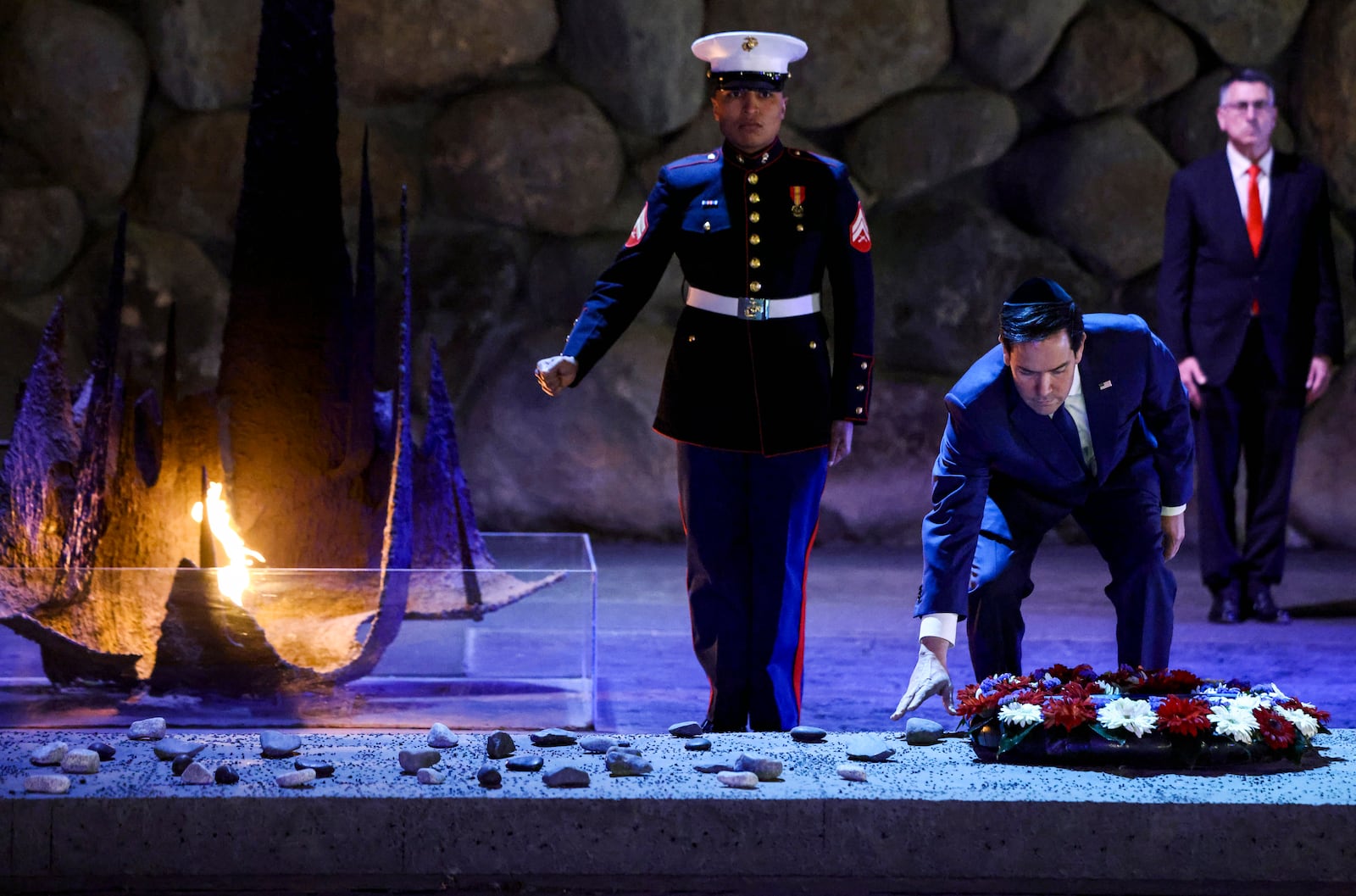 US Secretary of State Marco Rubio, front right, lays a wreath before the Eternal Flame at the Hall of Remembrance at Yad Vashem, the World Holocaust Remembrance Center, in Jerusalem, Israel, Sunday Feb. 16, 2025. (Evelyn Hockstein, Pool Photo via AP)