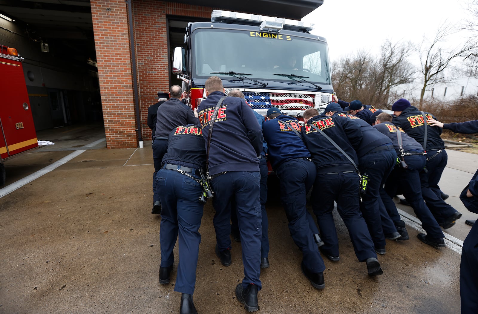 Springfield Fire Chief Jacob King and members of the Springfield Fire Division push in a new engine Thursday, Feb. 6, 2024 to station five on Commerce Dr. MARSHALL GORBY\STAFF