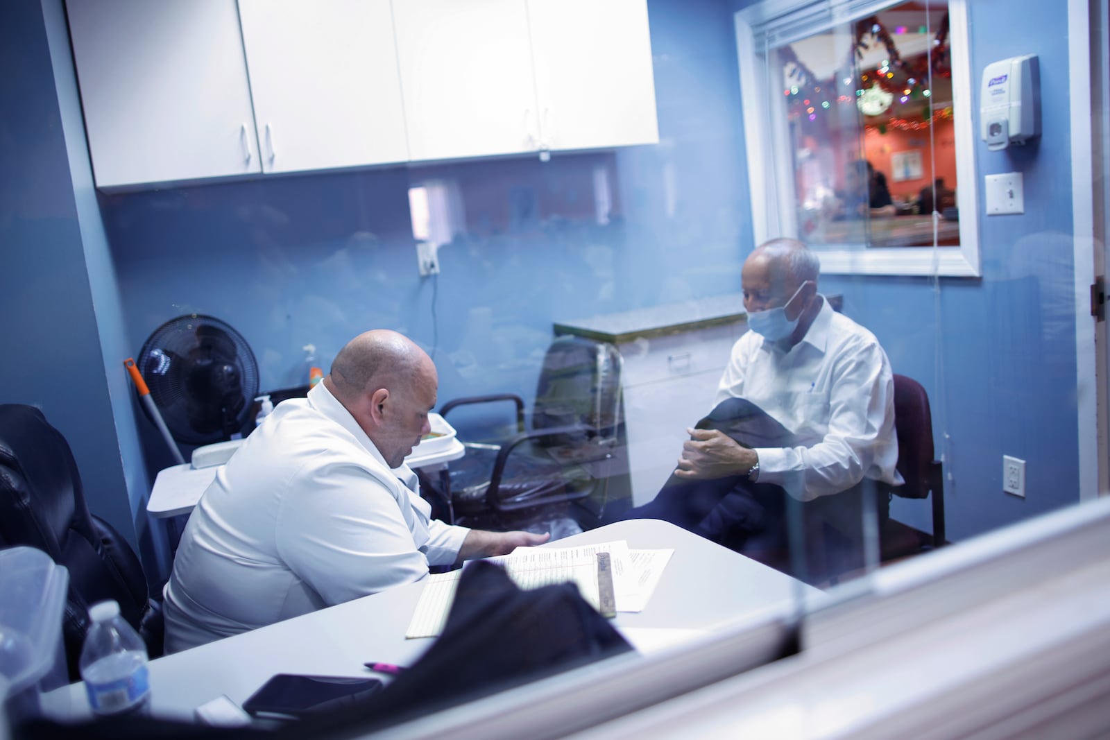 A man, left, receives a podiatrist treatment at Sunshine Adult Day Center in Bergenfield, N.J., Monday, Aug. 26, 2024. (AP Photo/Kena Betancur)