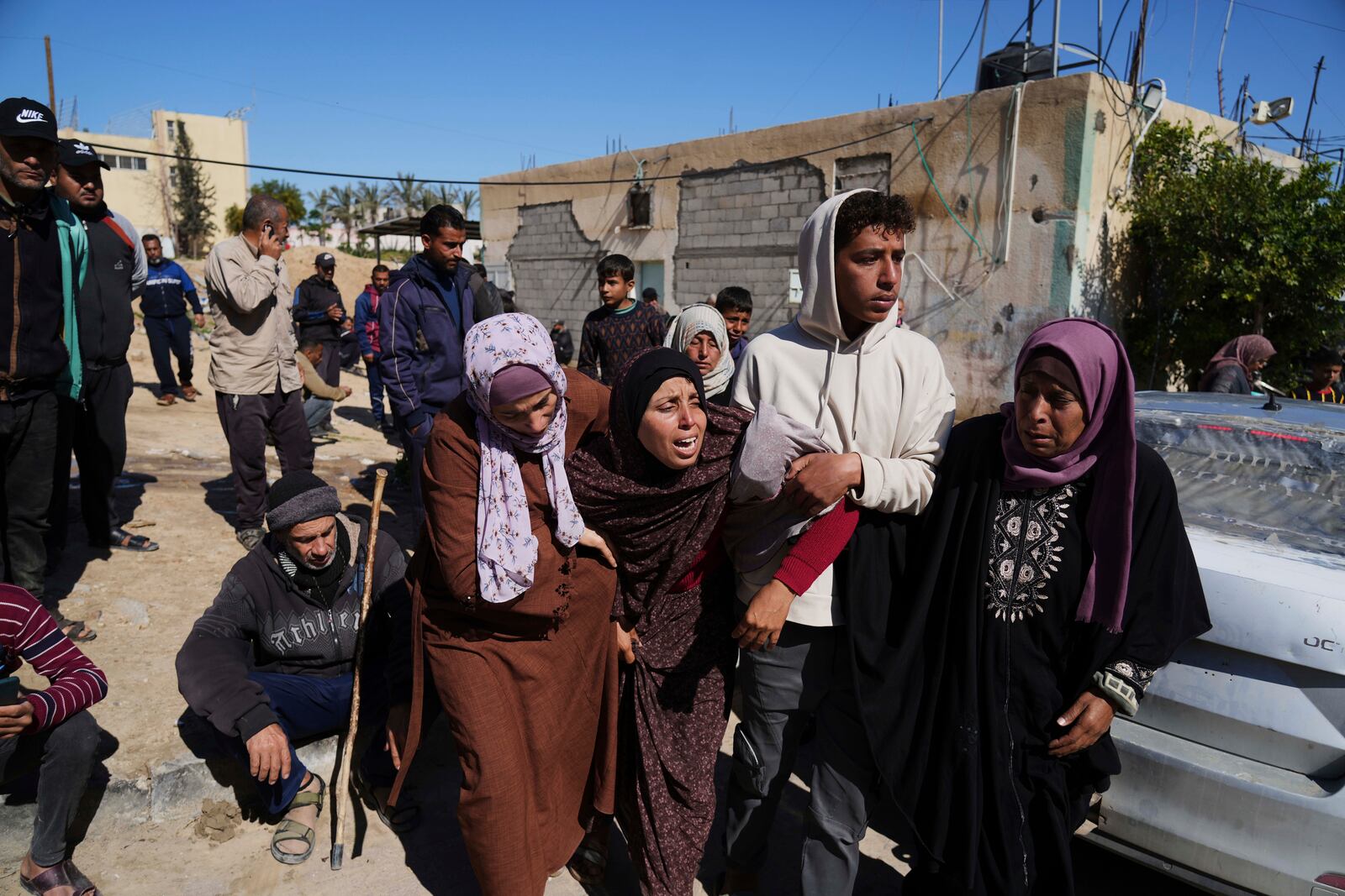 Mourners react during the funeral of Palestinians killed in the Israeli bombardment of the Gaza Strip at Nasser Hospital in Khan Younis, Sunday, March 23, 2025. (AP Photo/Abdel Kareem Hana)