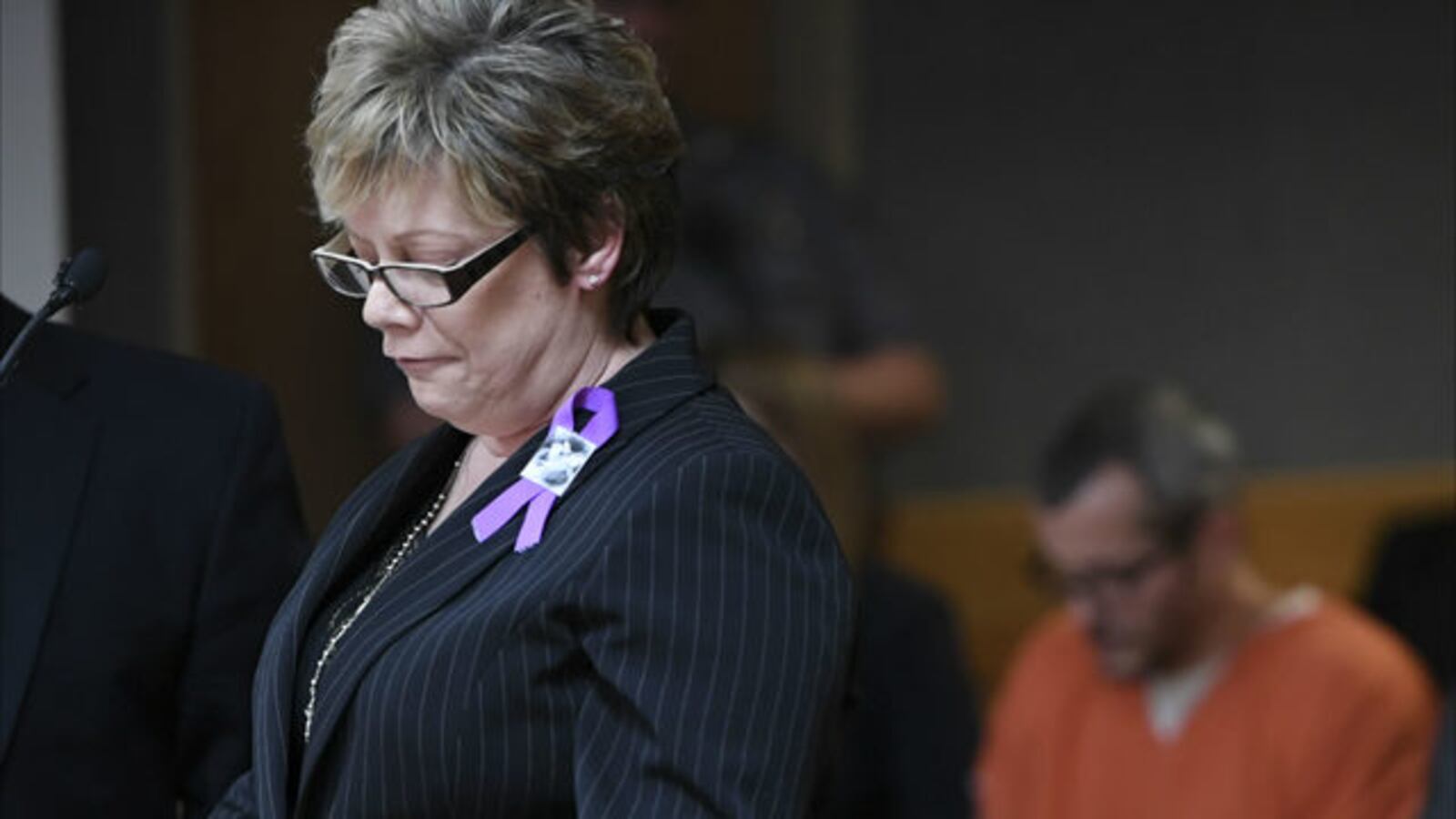 Shanann Watts' mother, Sandra Rzucek, reads a statement Nov. 19, 2018, in a Colorado courtroom as her son-in-law, Chris Watts, sits in the background. Chris Watts is serving multiple life sentences in the deaths of his wife and their two daughters.